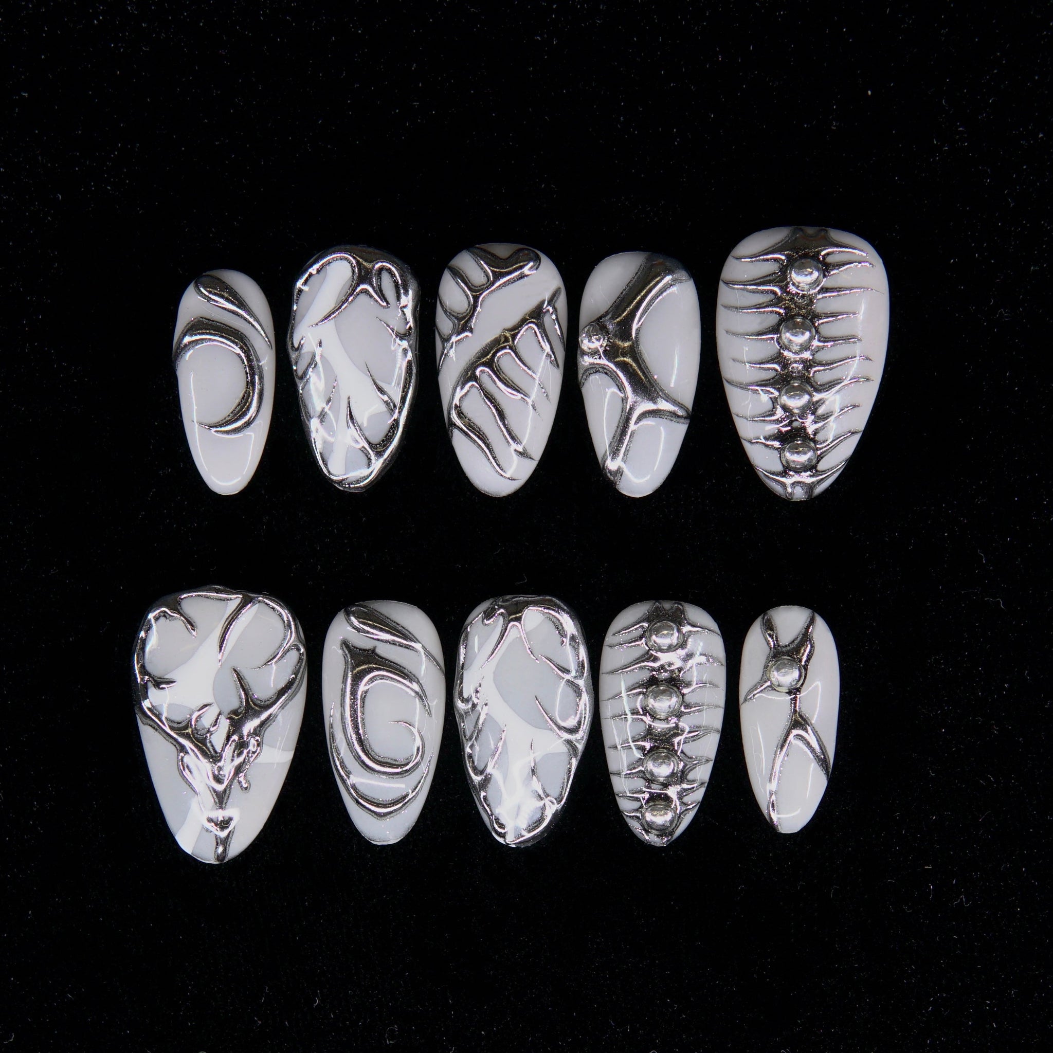 Argent Code press-on nails — monochrome base with abstract chrome circuitry, short almond shape.