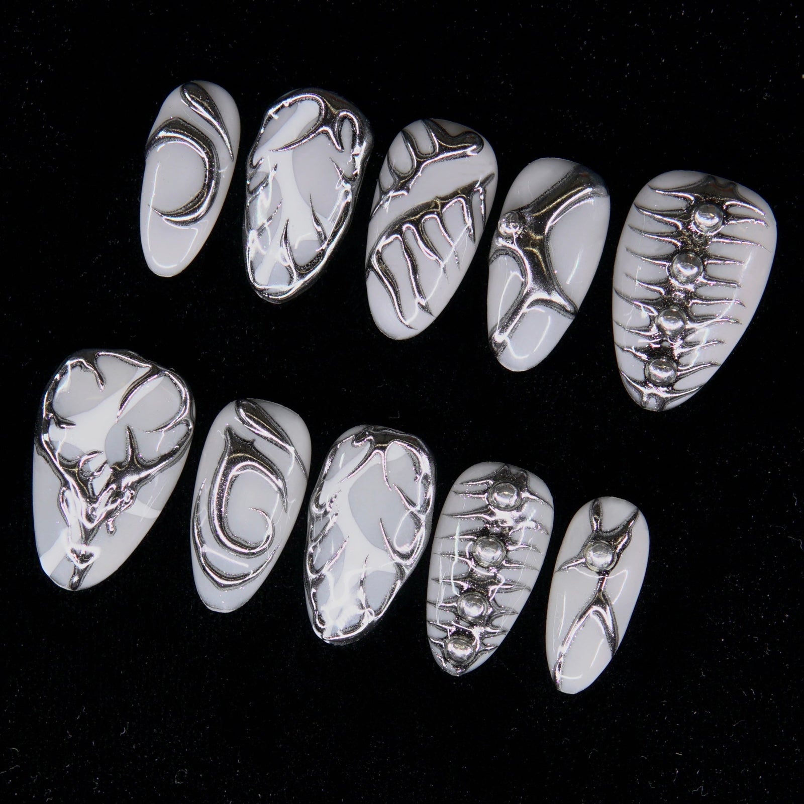 Close-up showing sculpted silver linework and metallic reflections.