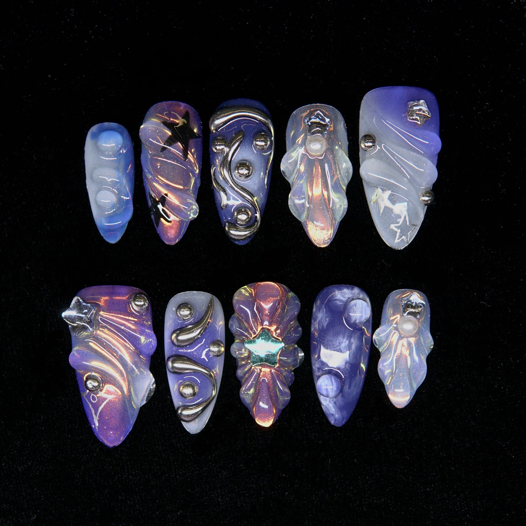 Astral Sediment press-on nails — purple and blue chrome gradient with cosmic metallic accents.