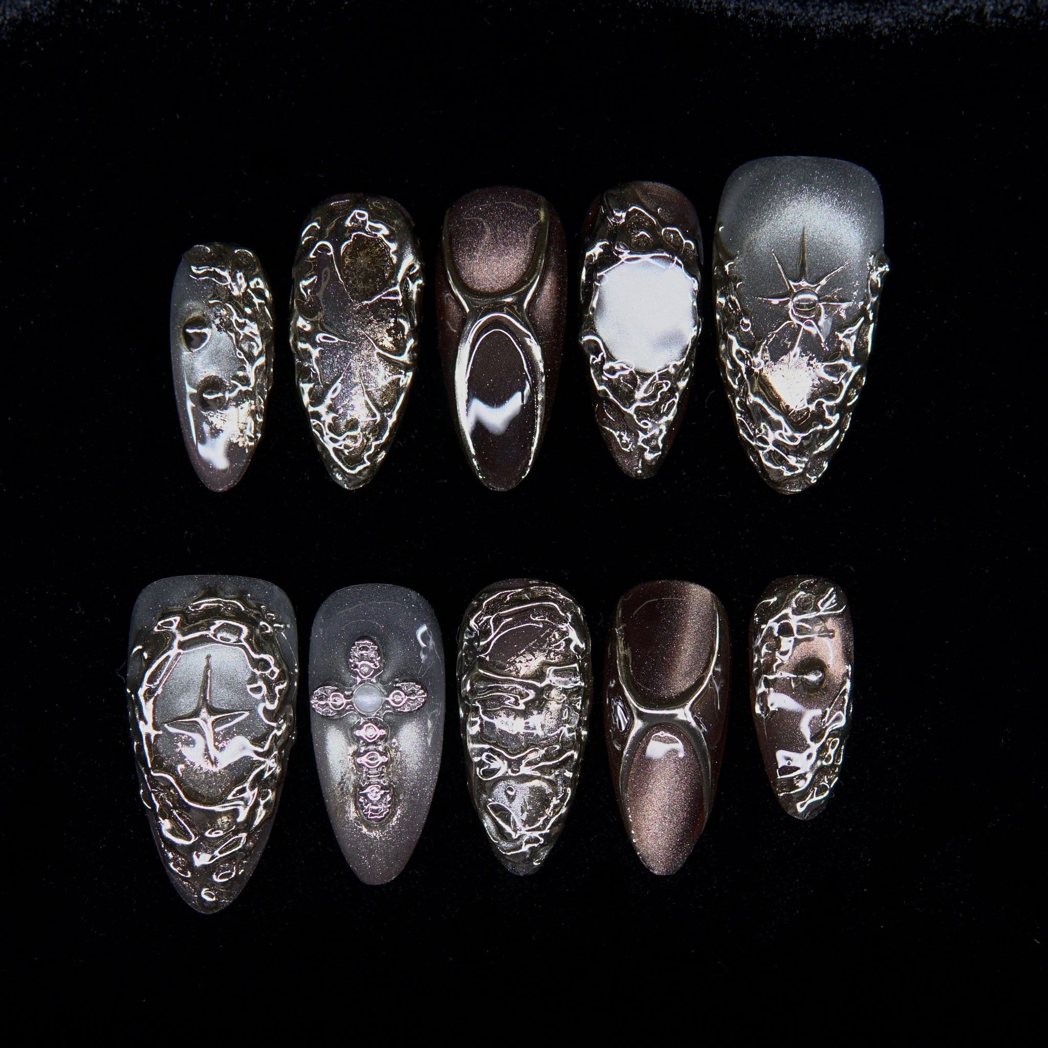 Aurum Vein press-on nails — bronze and silver metallic finish with molten chrome veins.