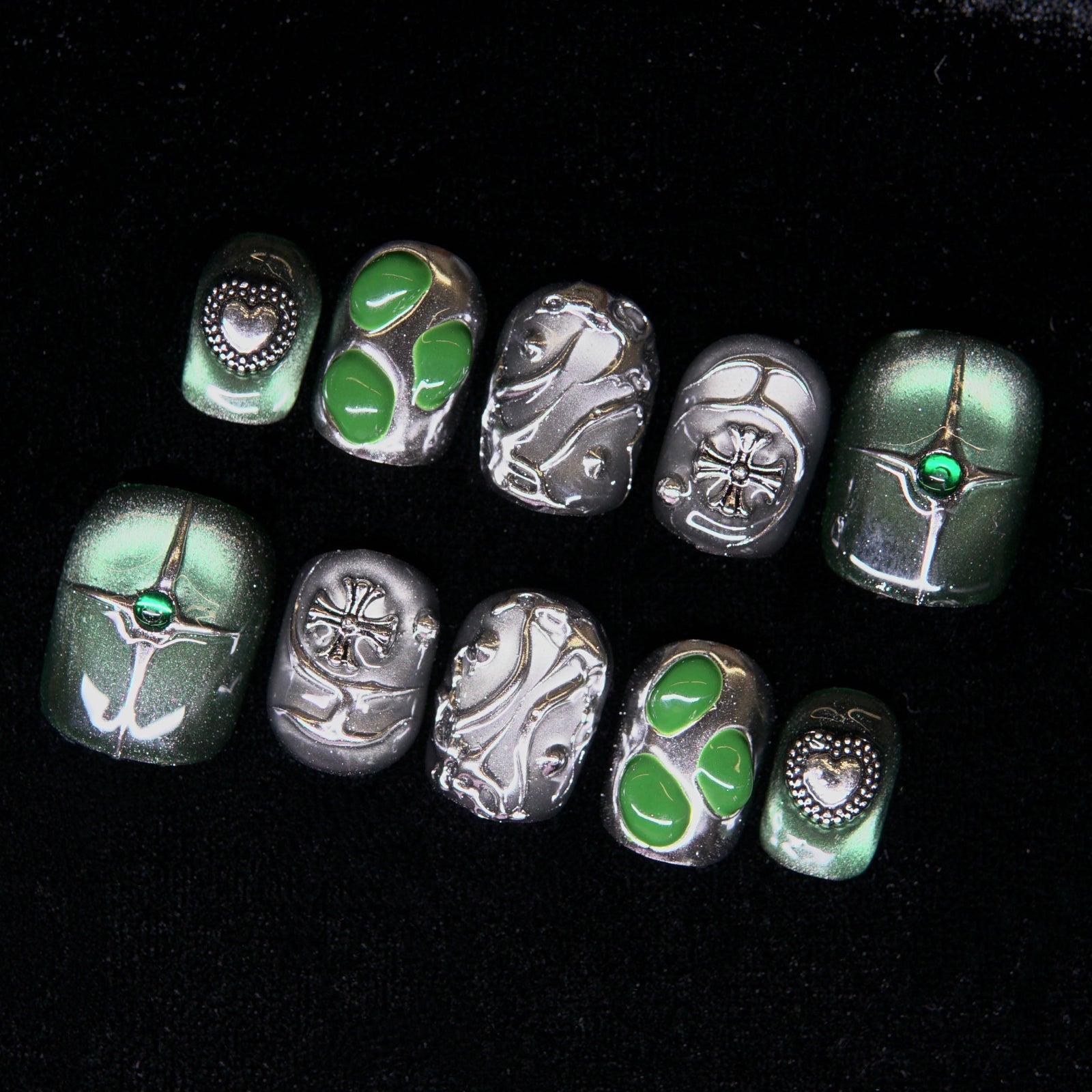 Close-up of engraved silver elements and gem centerpiece.