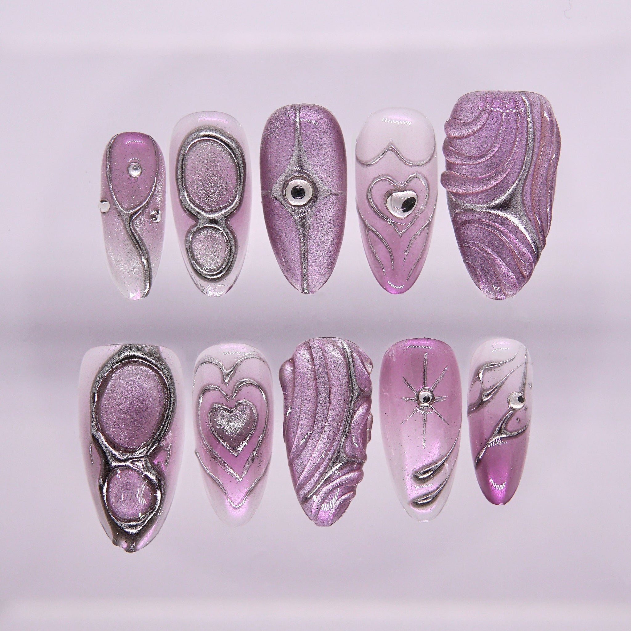 Purple-pink chrome press-on nails with silver lines and heart accents
