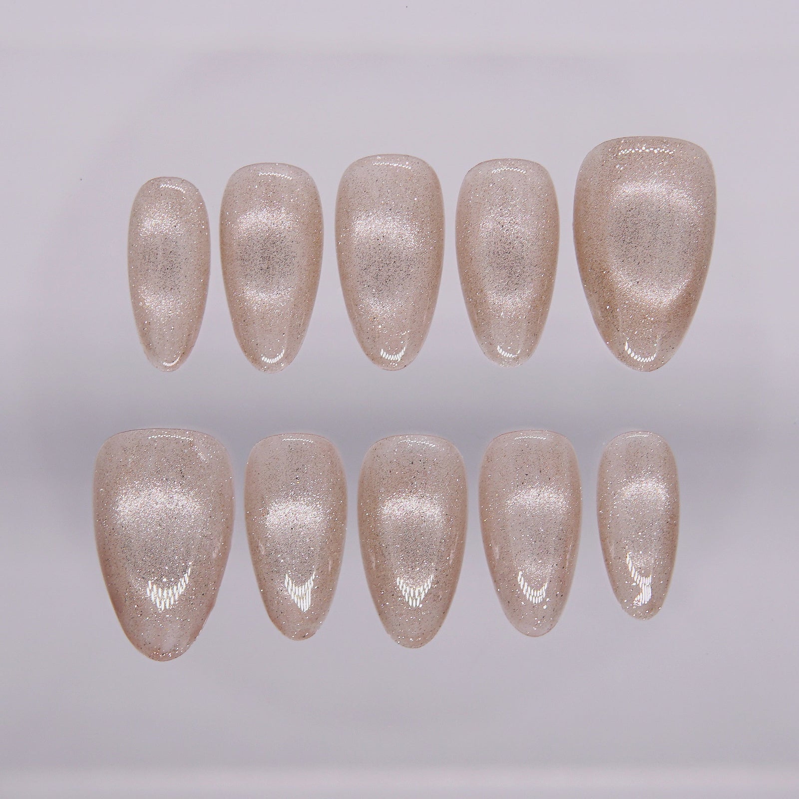 Champagne gold cat eye press-on nails displayed in full set – First Light by Nailsium