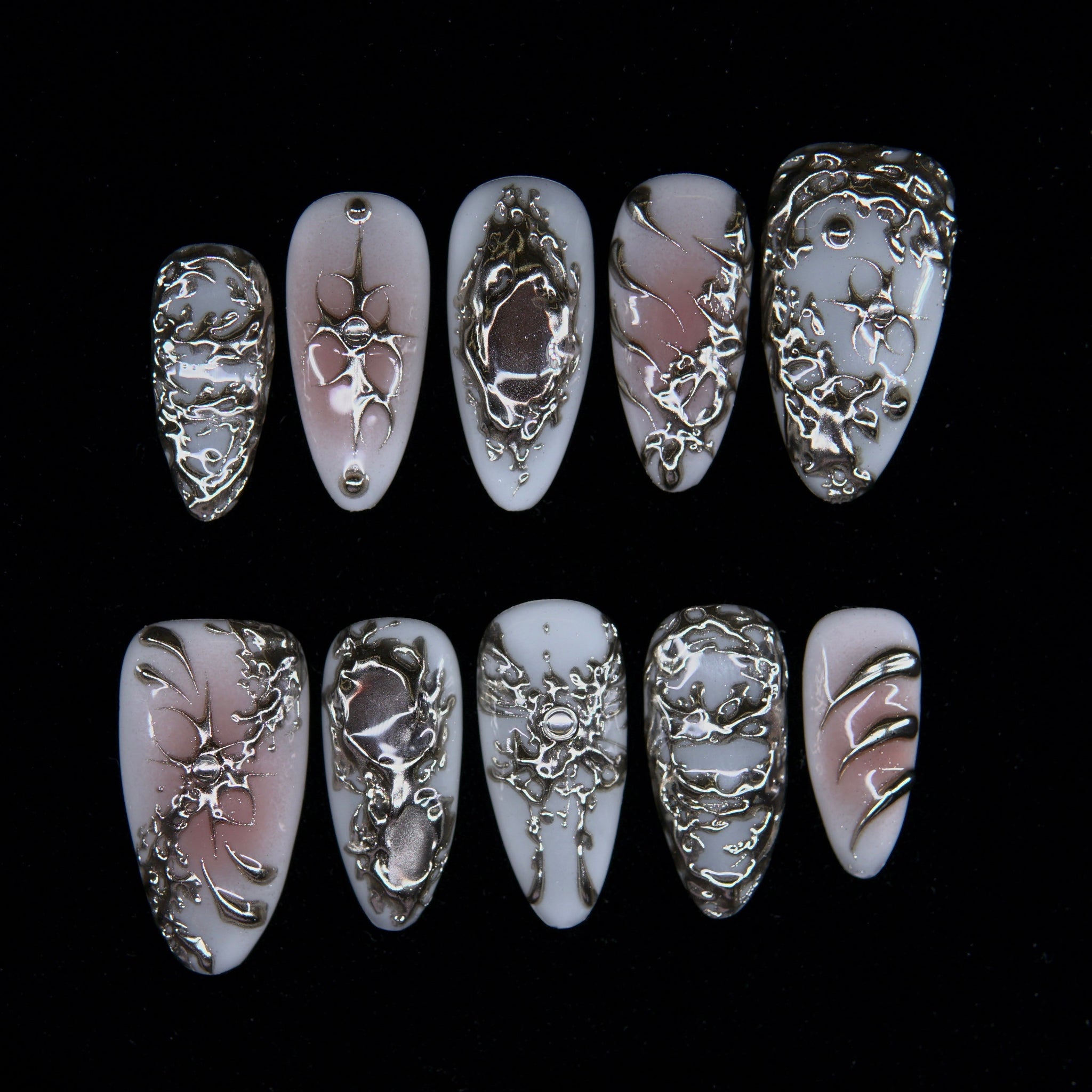 Ivory Transmute press-on nails — ivory blush base with molten silver textures.