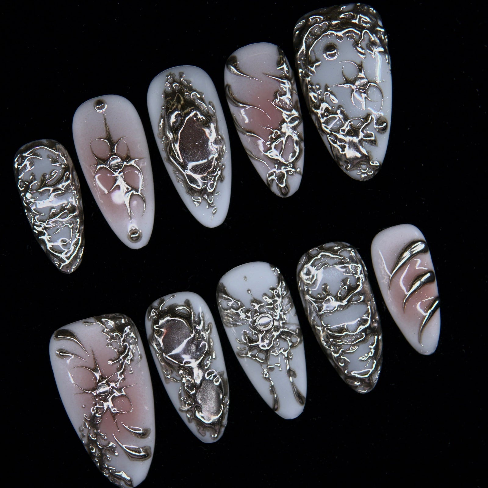 Close-up of crystallized metallic overlay on soft ivory surface.