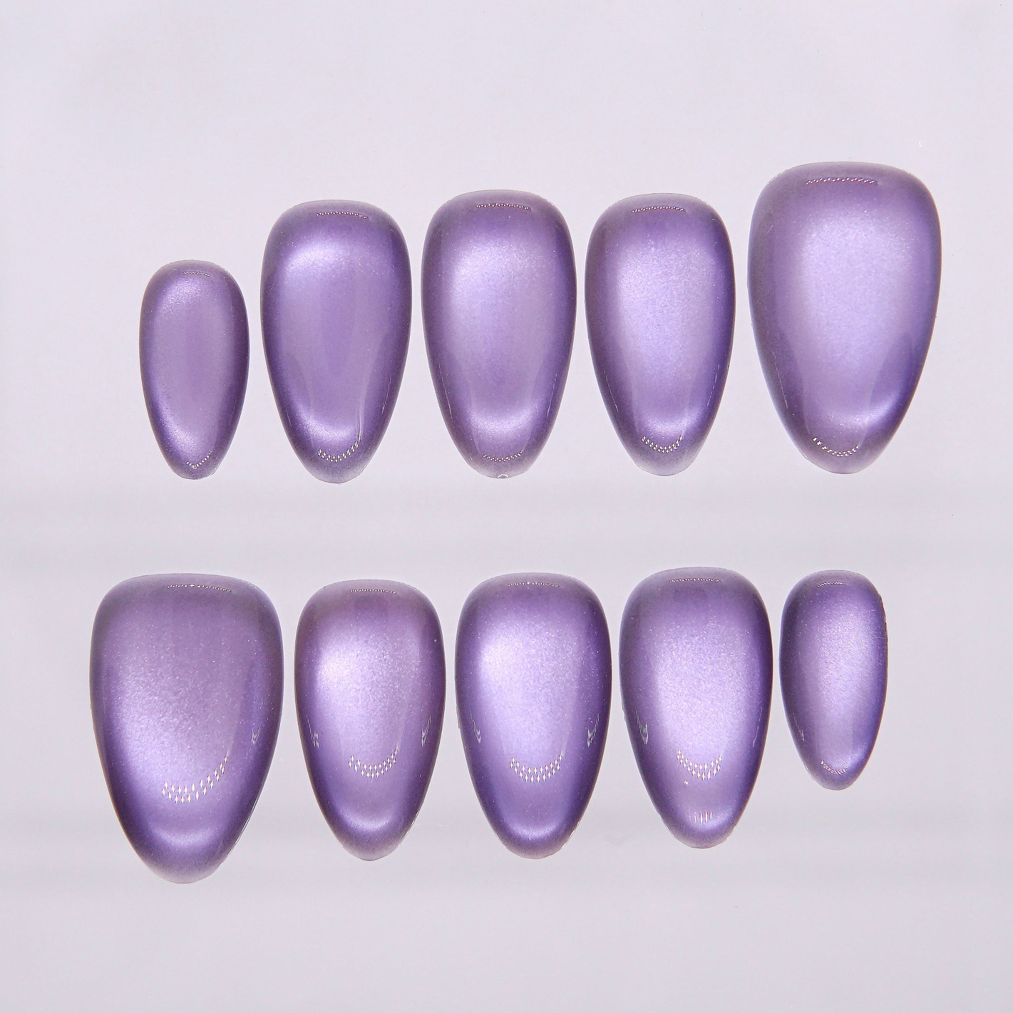Soft lilac cat eye press-on nails with dreamy shimmer.
