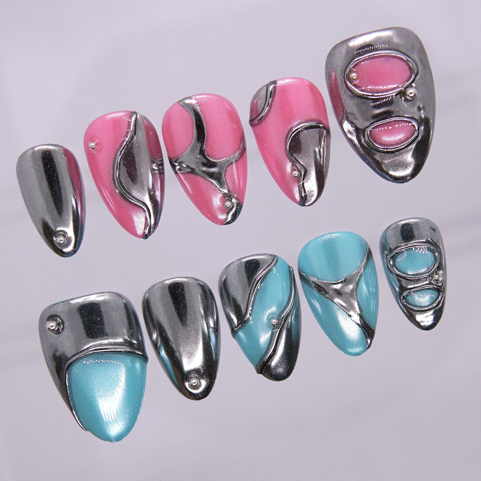 Mirror Error press-on nails with chrome accents and mixed nail lengths.