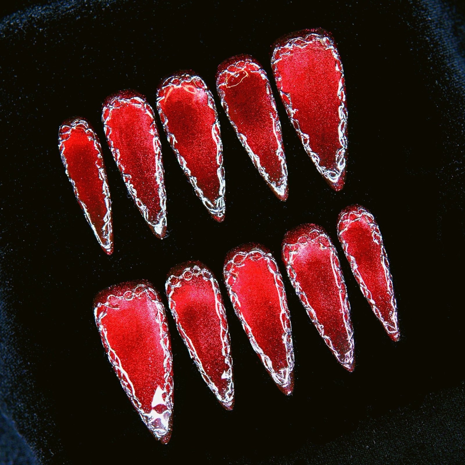 Close-up of hand-painted silver framing and red gradient effect.