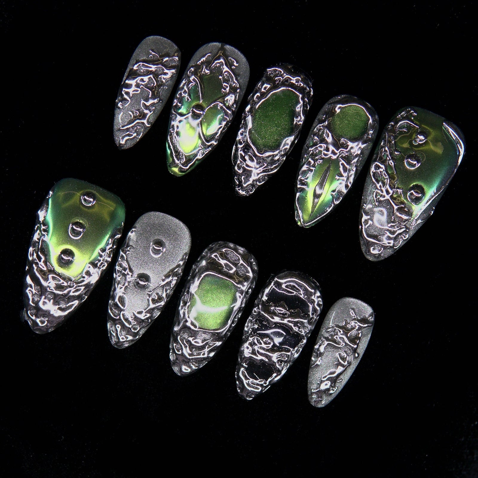 Close-up of molten silver veins surrounding metallic green core.