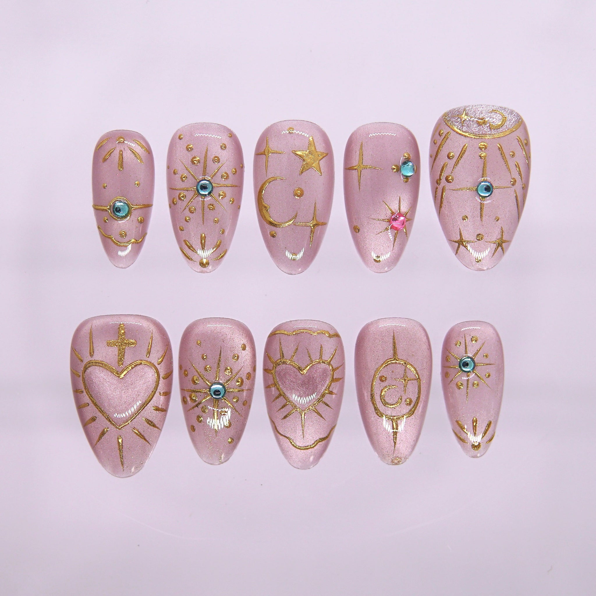 Lilac press-on nails with gold celestial motifs and gem accents from Sugar Dream Series.