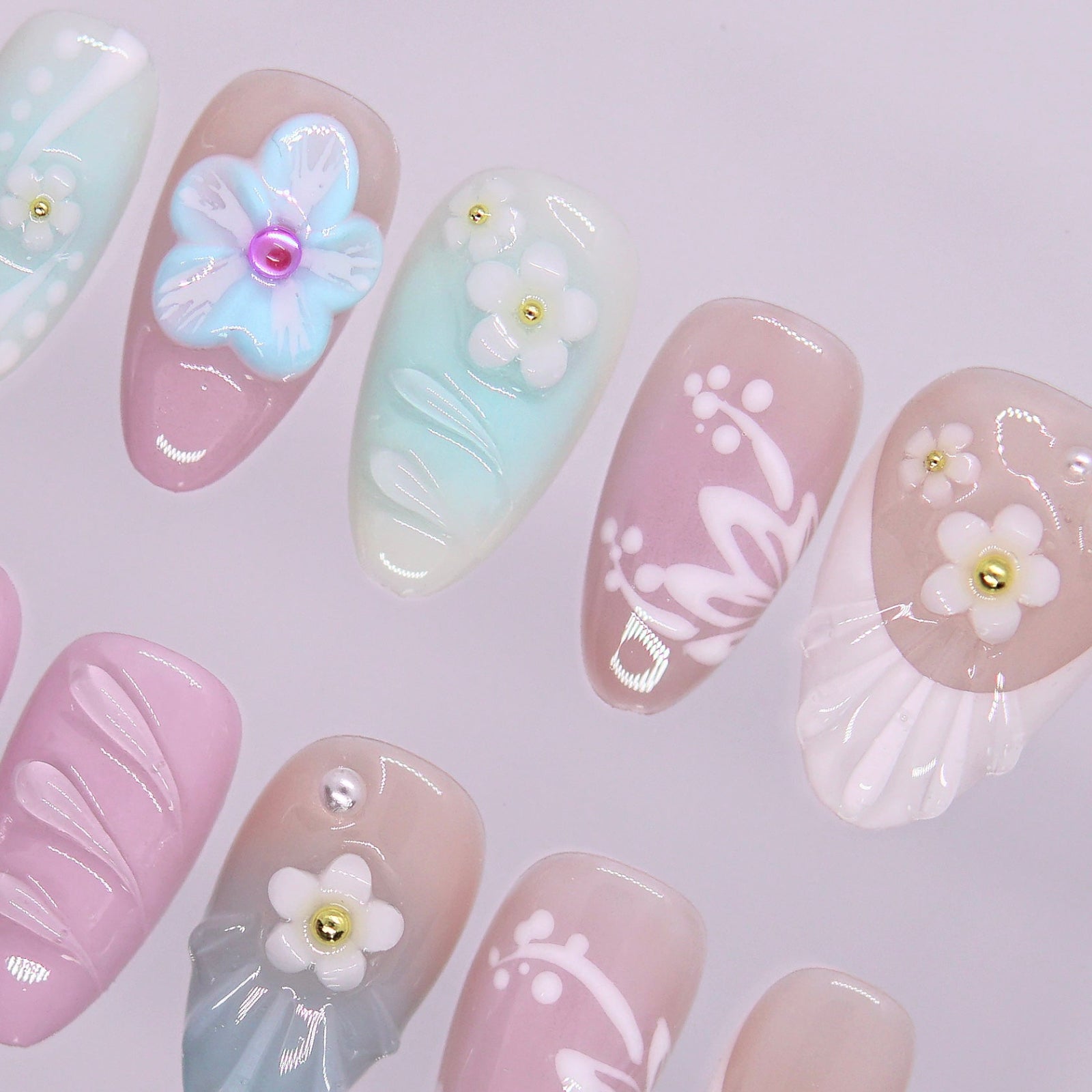 Soft mint, blush, and baby blue gradient press-on nails with candy-like pastel tones.