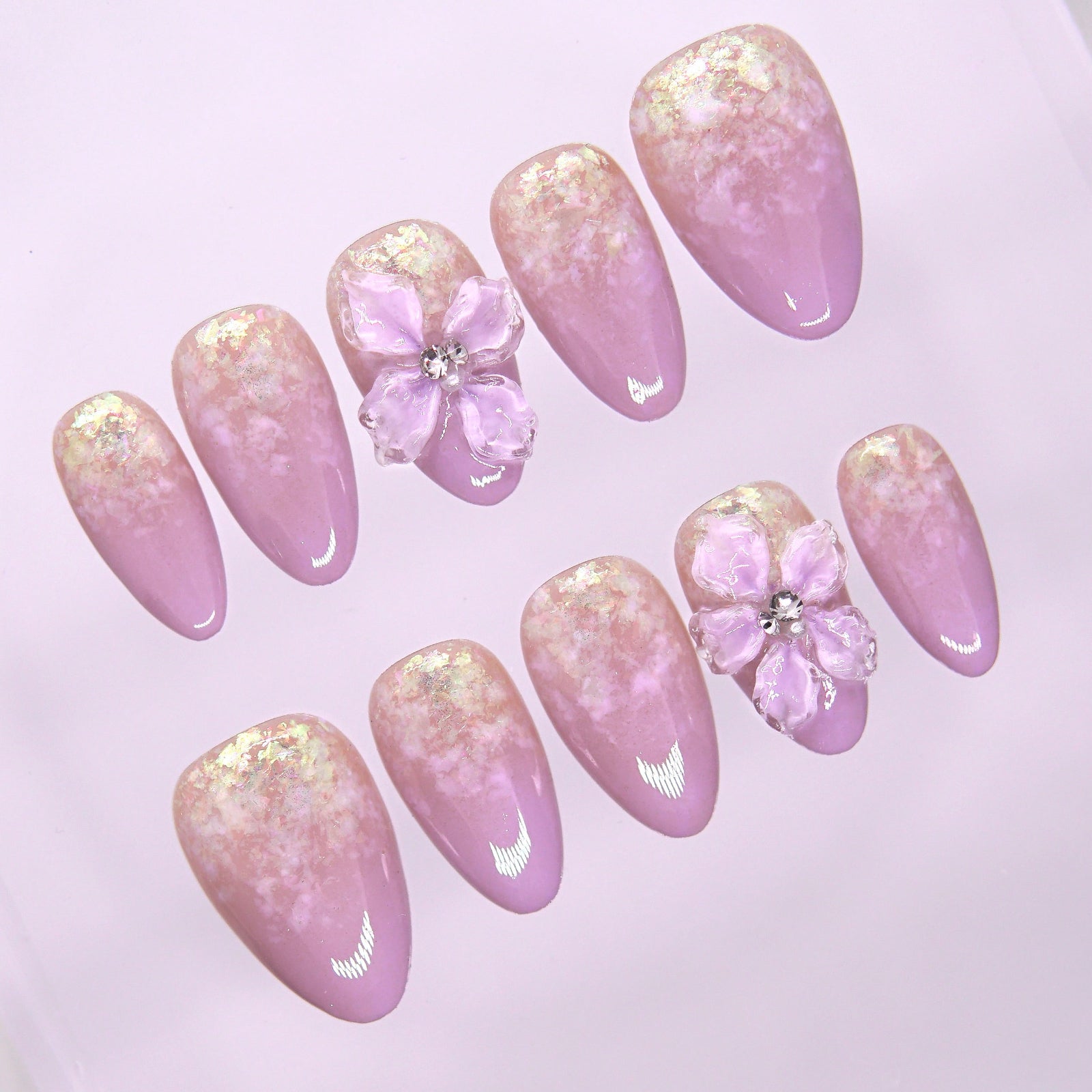 Detailed view of lavender ombré gradient with iridescent flakes on press-on nails.