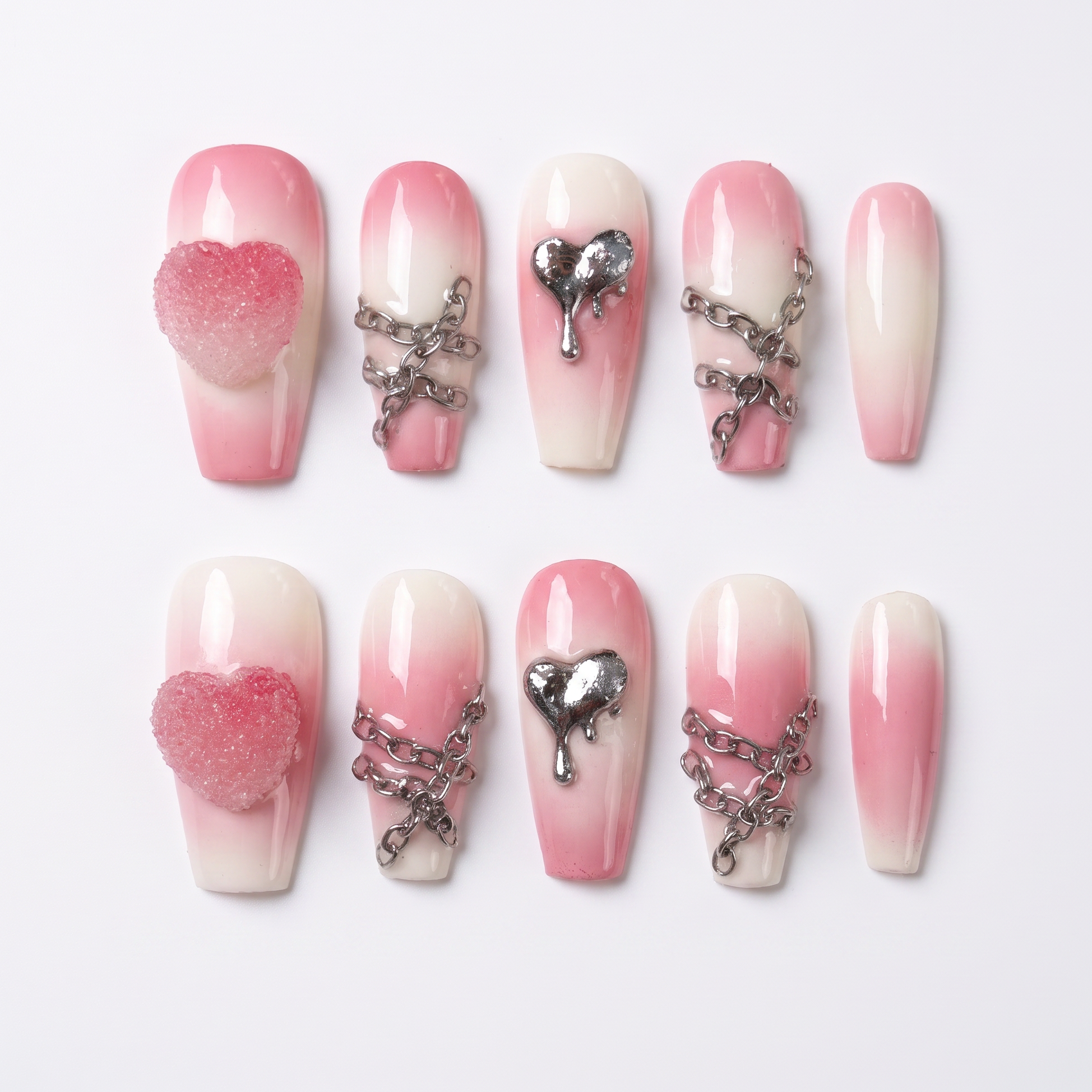 Pink-to-cream gradient press-on nails with silver chains and dripping heart charm – sweet yet edgy Fire Series design by Nailsium.