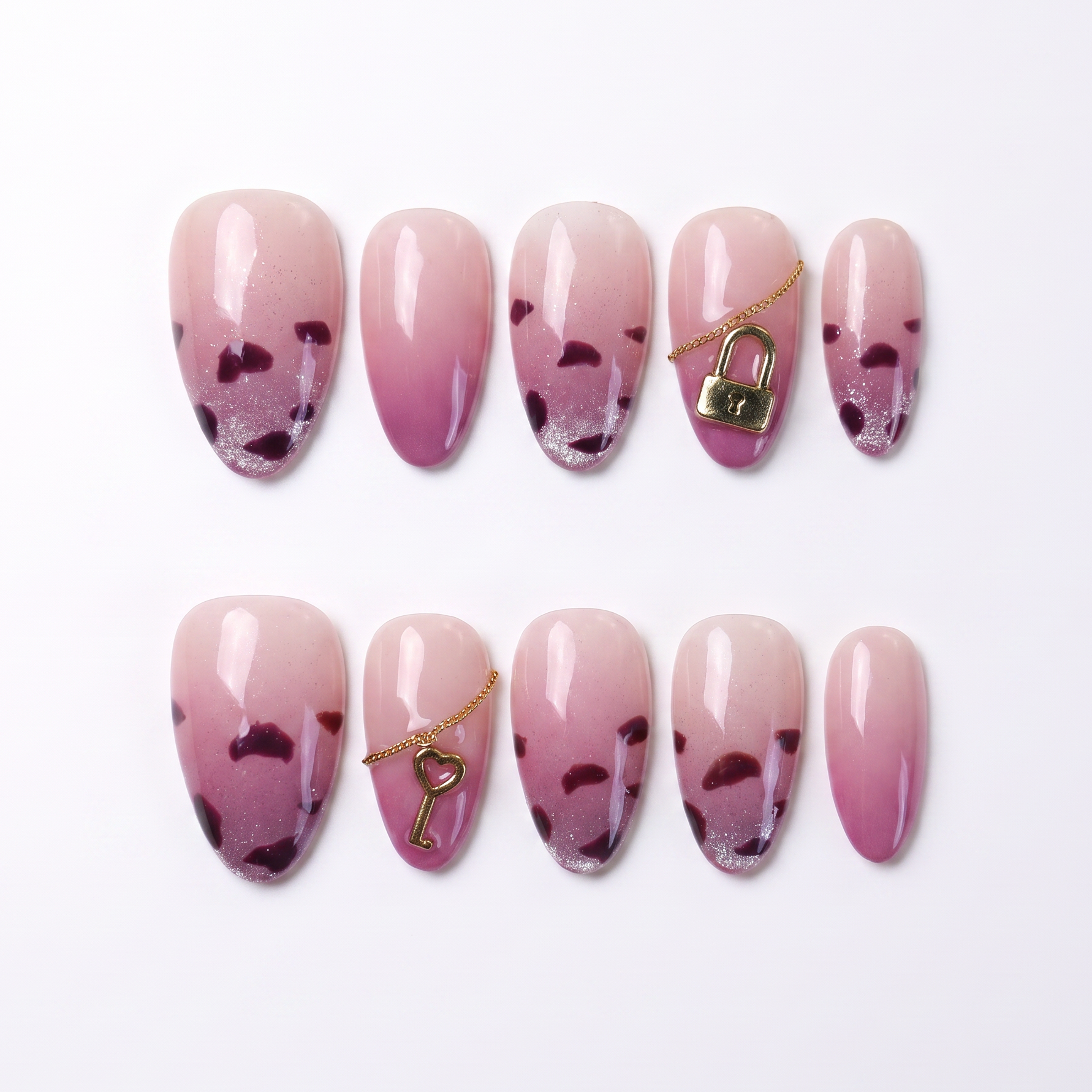 Glossy pink press-on nails with leopard tips, lock and key charms – full layout