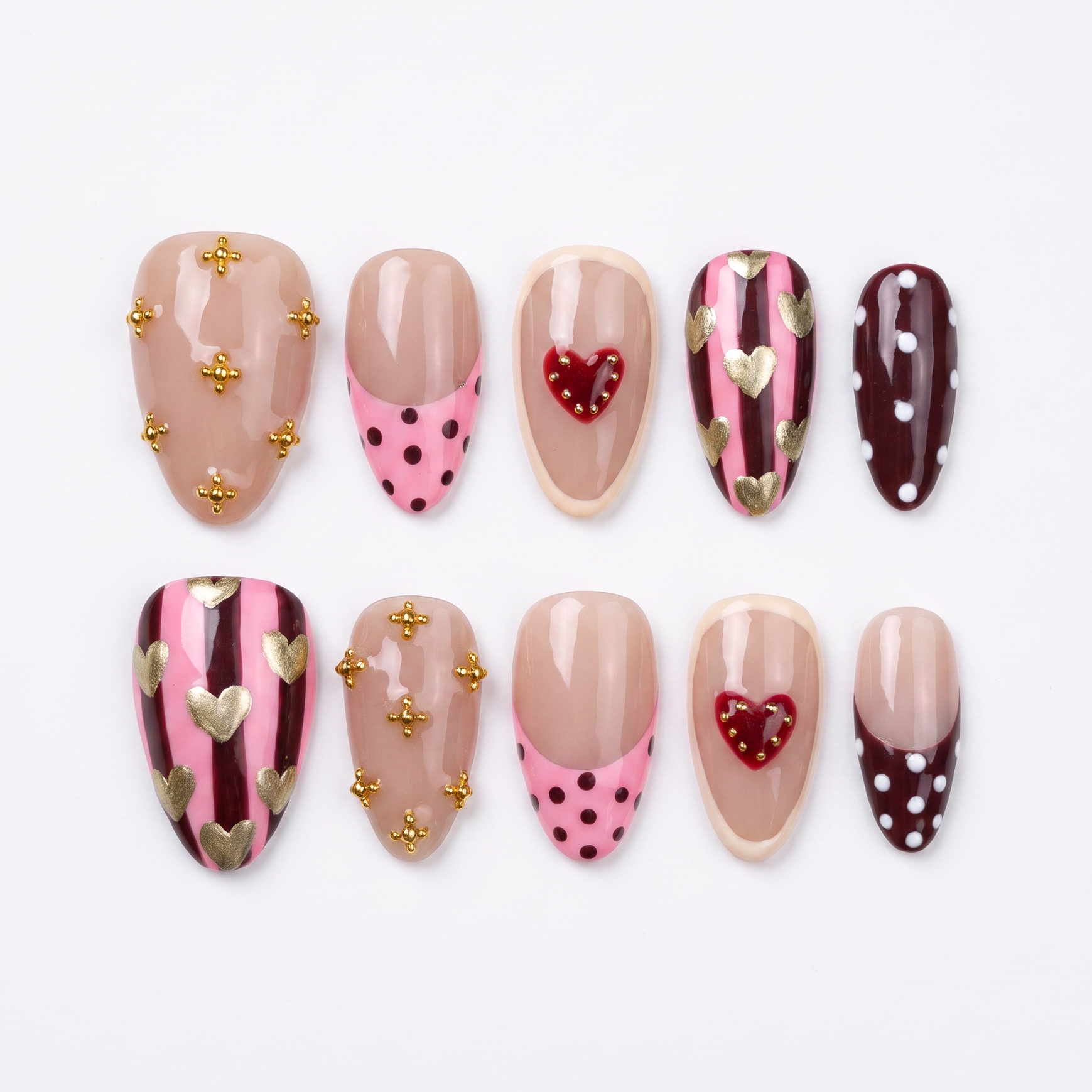 Horse zodiac press-on nails in blush nude with pink and burgundy heart and stripe designs, representing Liberty and free spirited self love.
