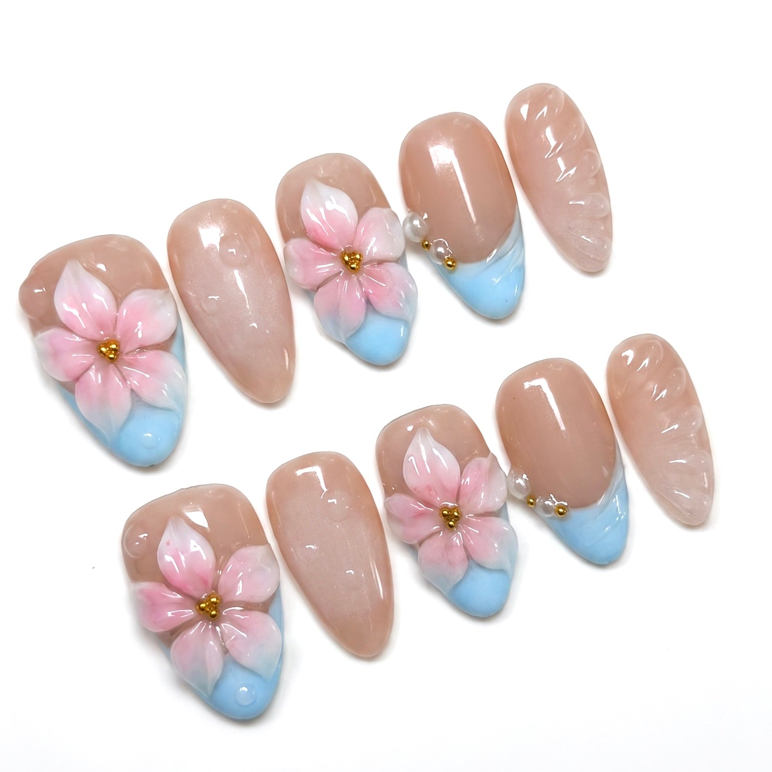 Close up of baby blue French tip with sculpted pink flower and gold bead center.
