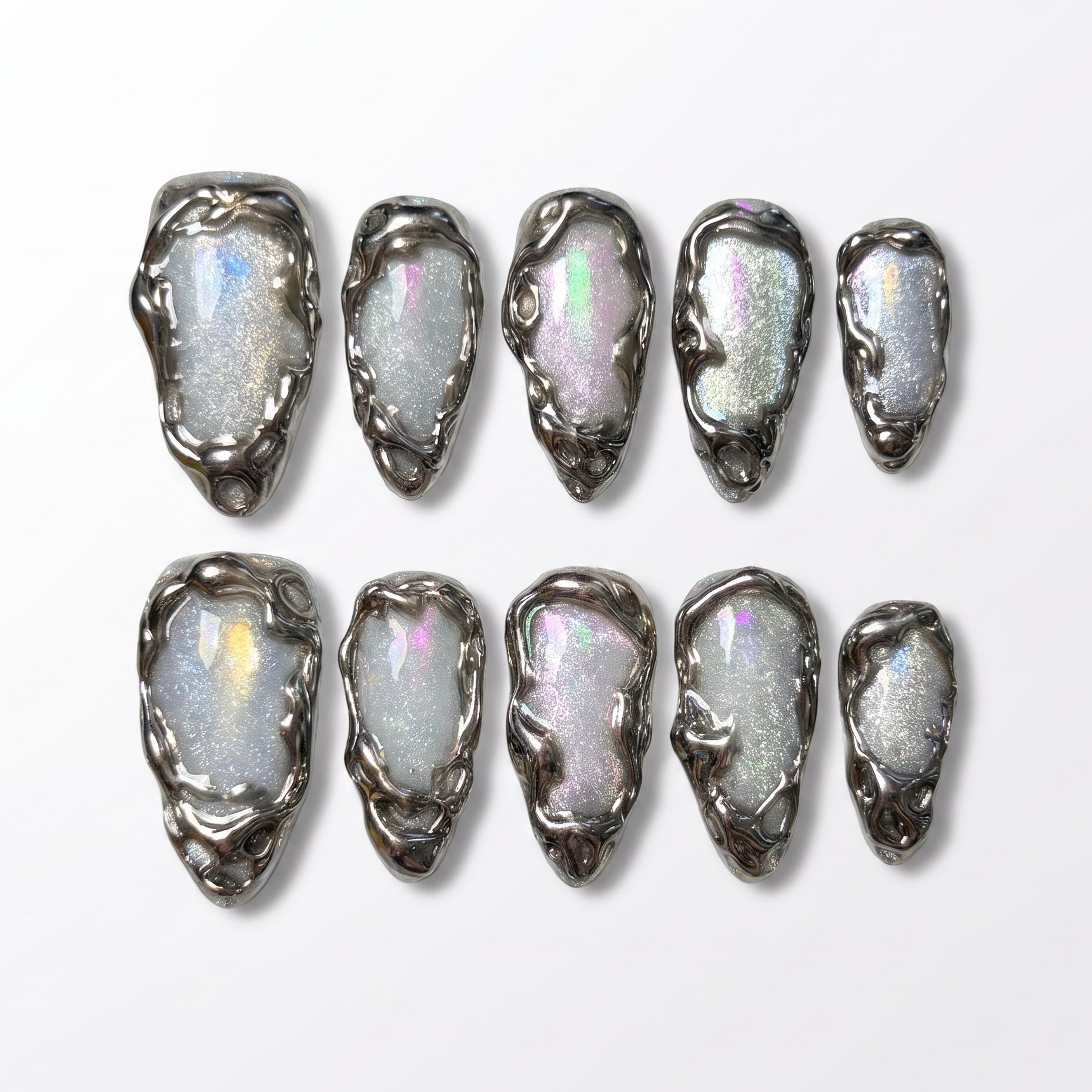 Handmade pearl chrome press-on nails with sculptural liquid silver details inspired by shimmering summer pool reflections.
