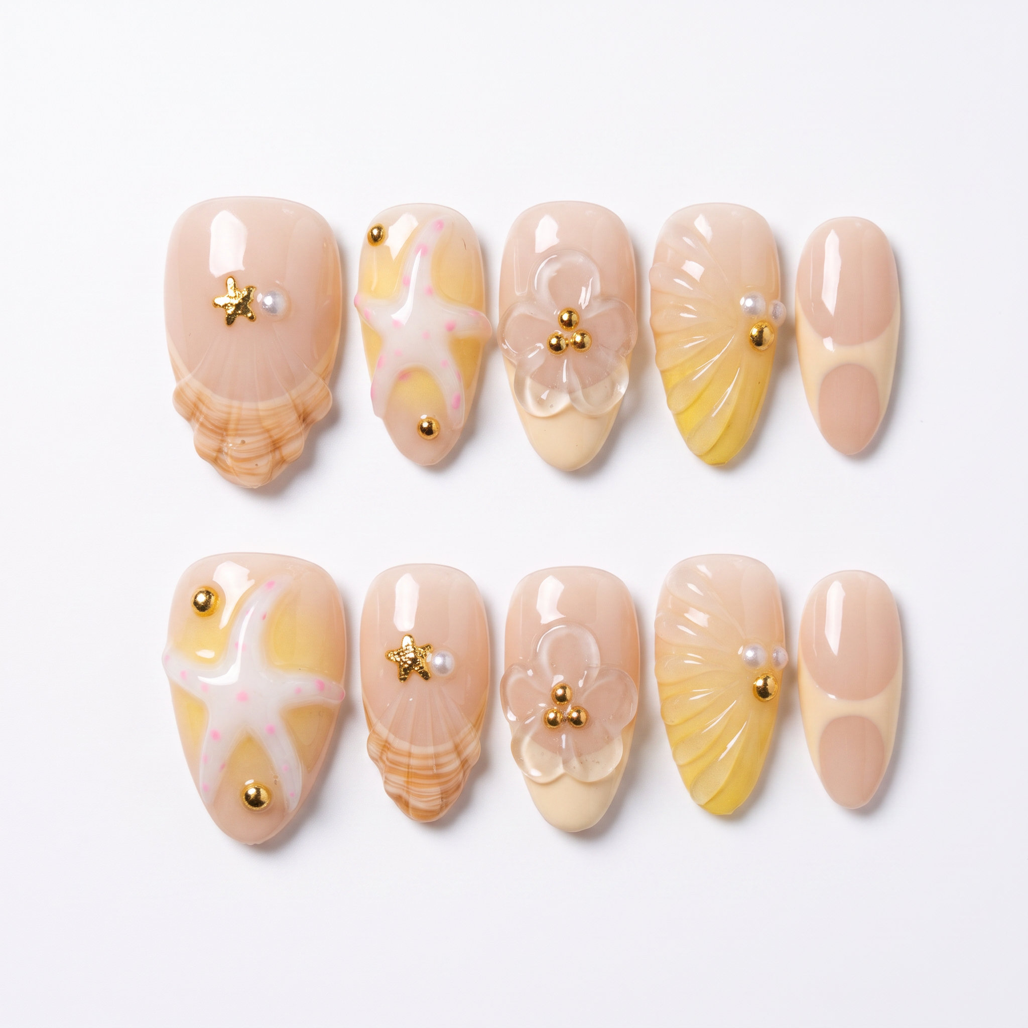 Handmade summer press-on nails featuring 3D seashells, starfish, butter yellow details, flowers, pearls, and glossy finish.
