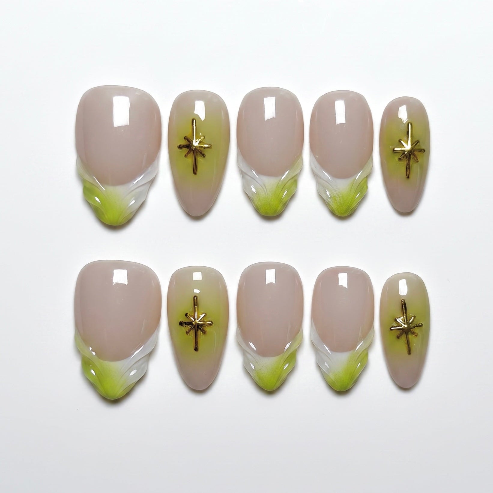 Handmade lime green French tip press-on nails with gold star charms and glossy nude finish.
