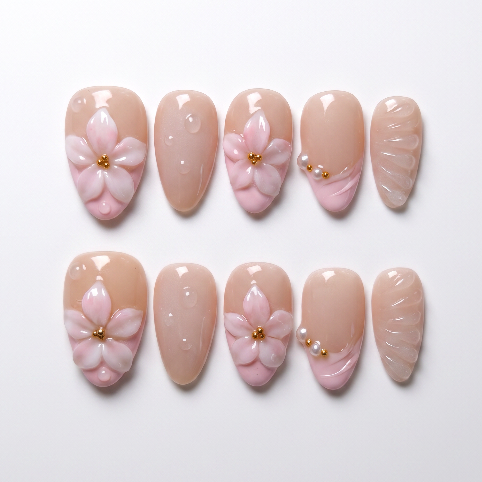 Pink 3D flower press on nails with blush French tip and gold bead center on nude base.