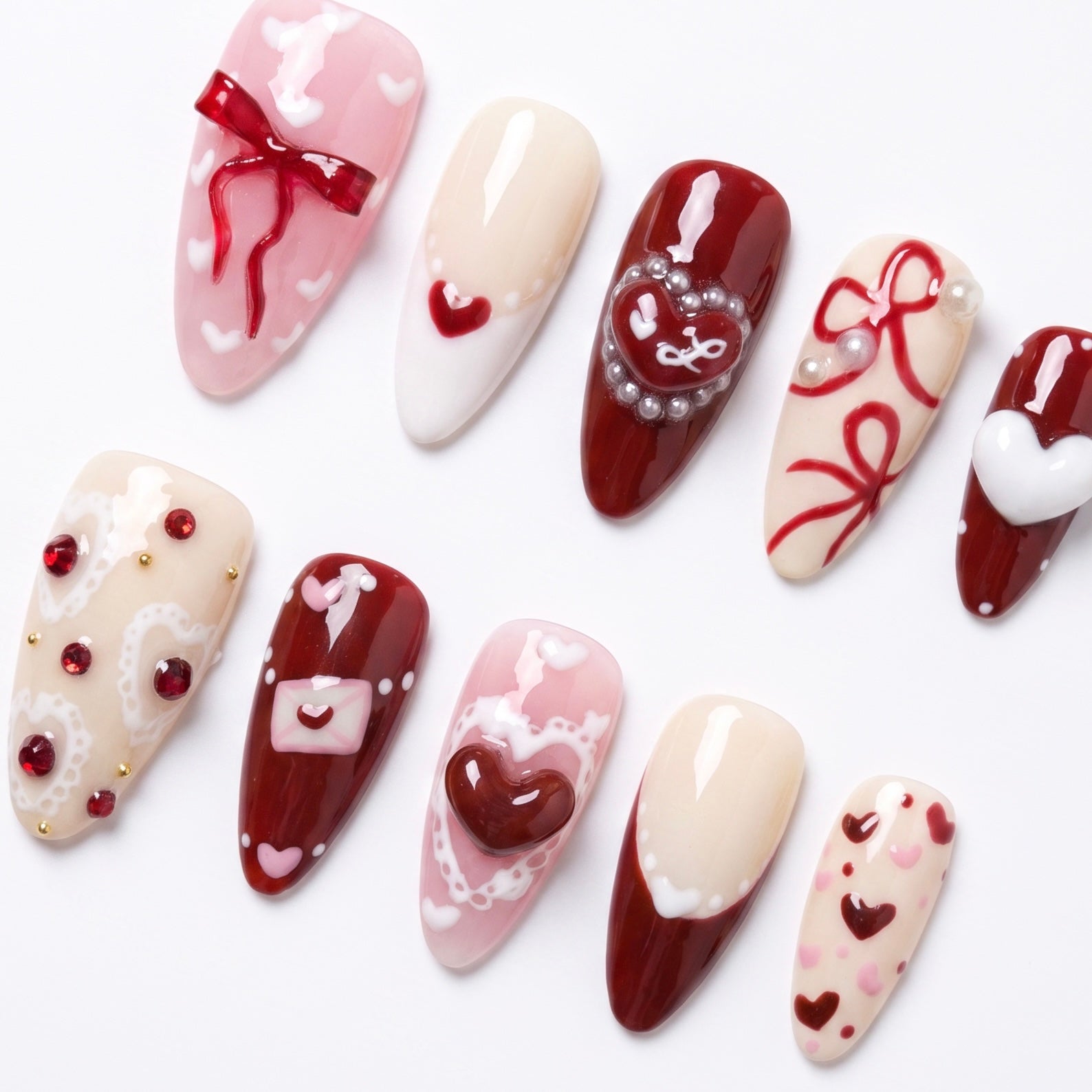 Close up of Rooster Radiance press on nails with heart details and glossy finish
