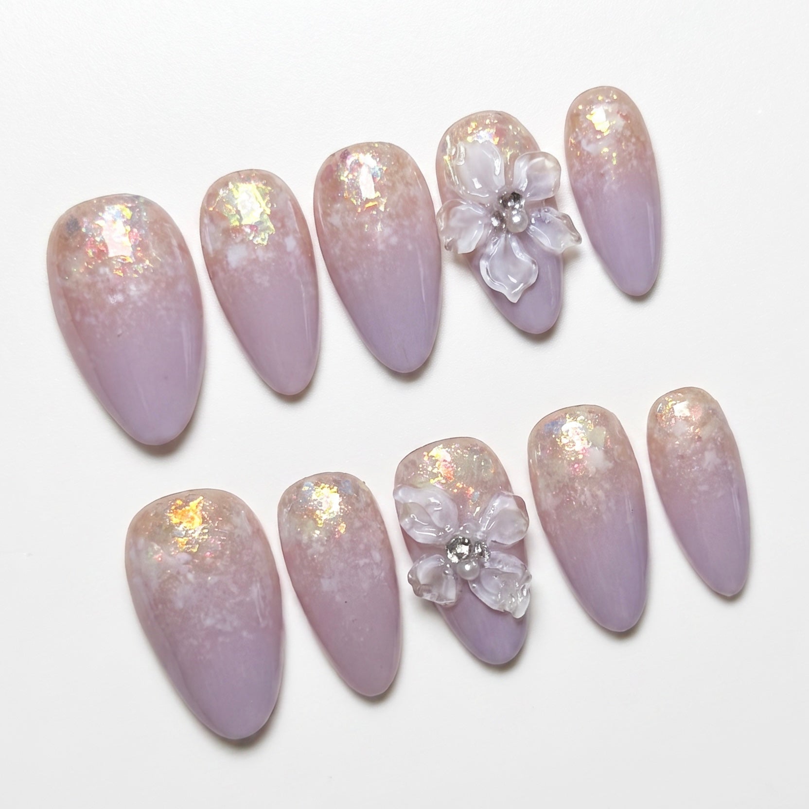 Detailed view of lavender ombré gradient with iridescent flakes on press-on nails.