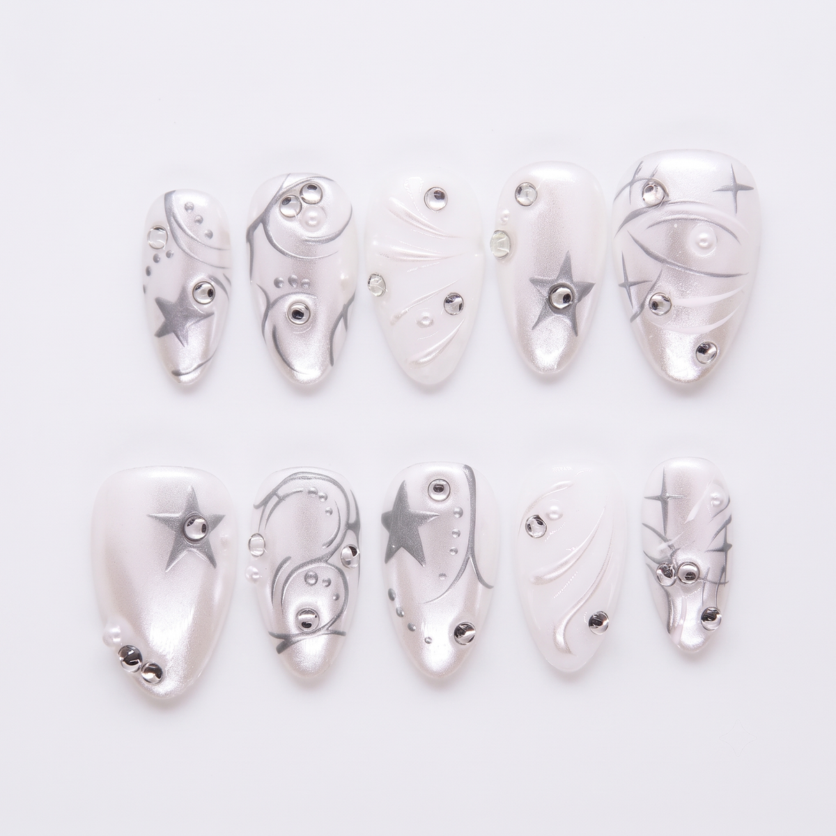 Star Circuit press-on nails with chrome silver, pearly white, and star-studded geometric details – cool Metal · Clarity design by Nailsium.