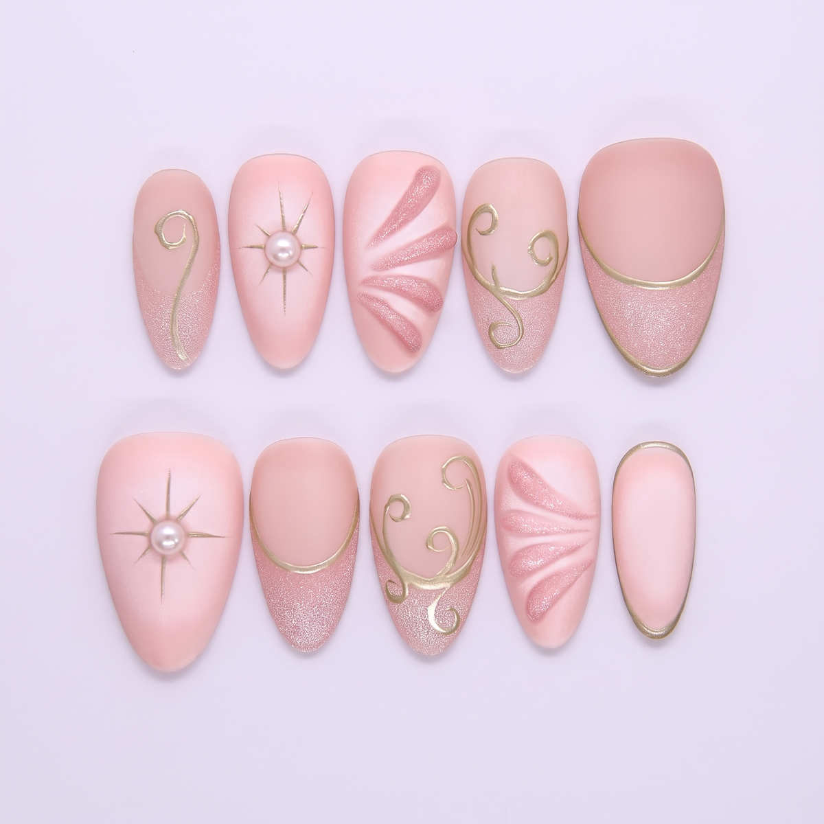 Begin with Trust press-on nails set featuring blush pink tones with celestial gold linework and soft shimmer finish