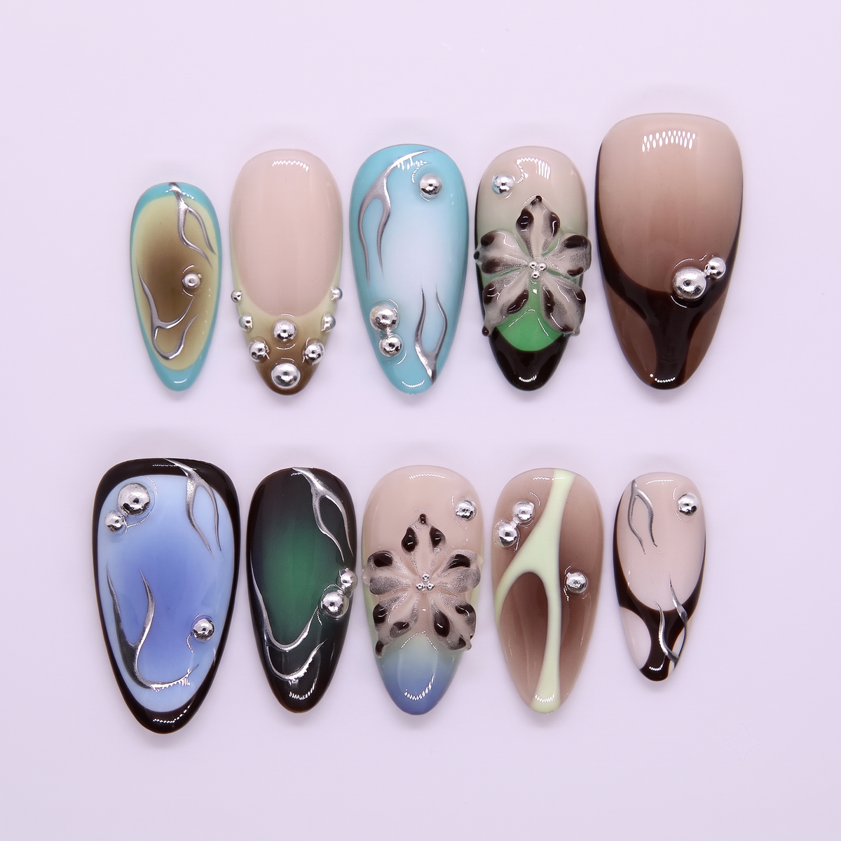 Blue-green gradient press-on nails with metallic studs.