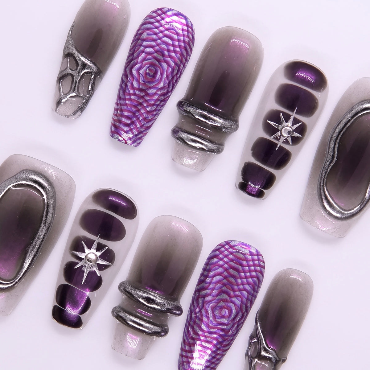 Close-up of sculpted chrome shapes and metallic purple hue on Night Bloom press-on nails
