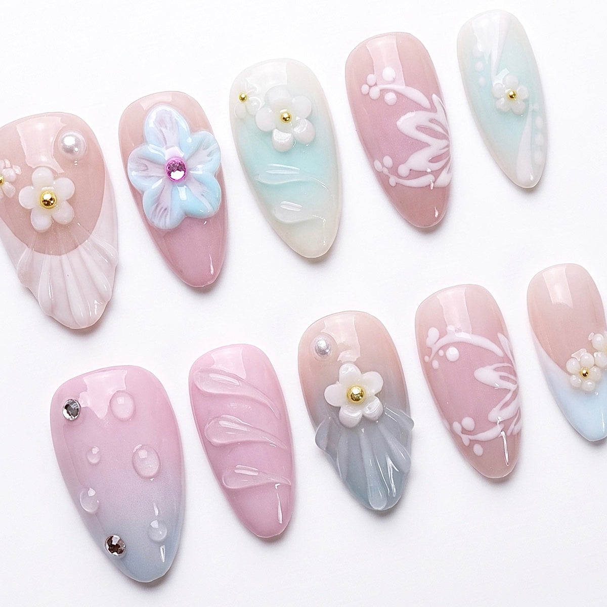 Soft mint, blush, and baby blue gradient press-on nails with candy-like pastel tones.