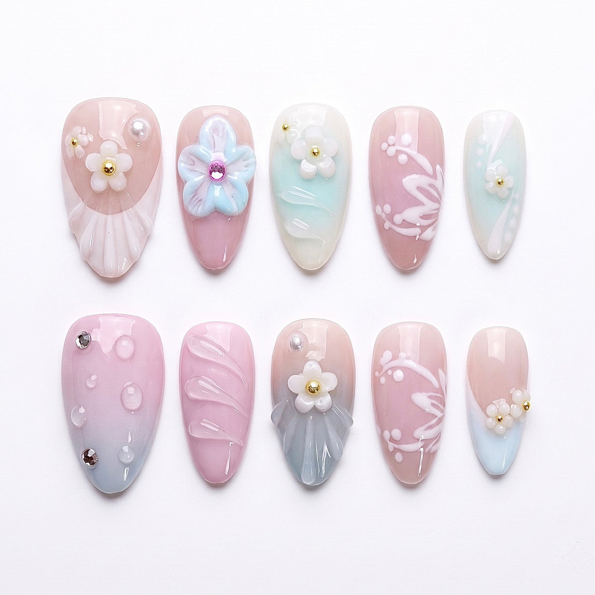 Candy Garden press-on nails with mint, blush pink, and baby blue pastels, pearly flowers, and shell accents – playful Wood · Bloom design by Nailsium.