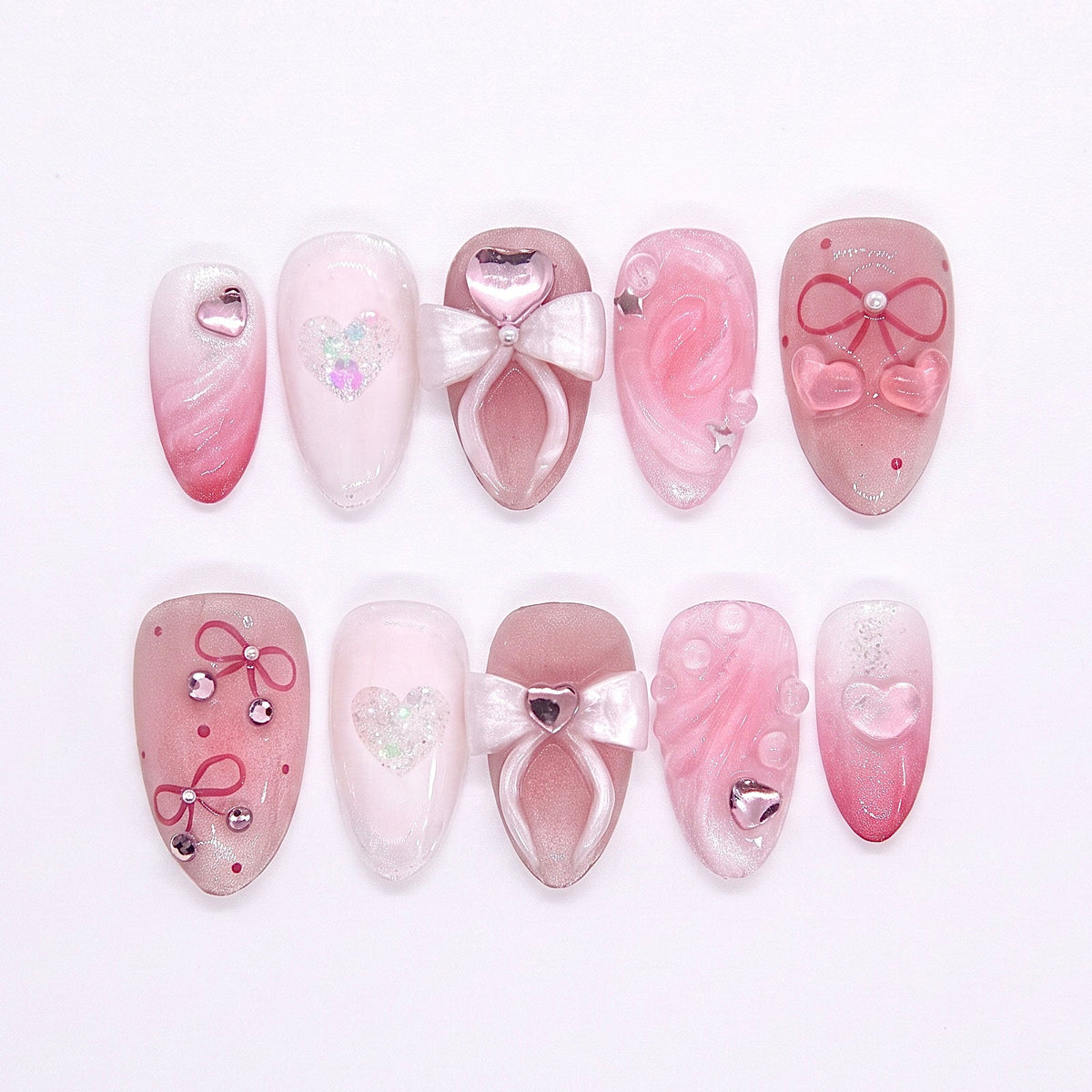 Room 328, La Valencia press-on nails featuring pink-to-white gradient, 3D sculpted bows, glitter hearts, and floral carvings — part of the La Jolla · Wood · Bloom collection.
