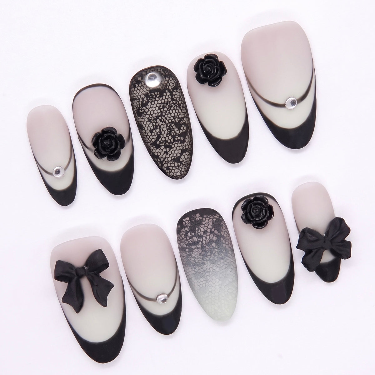 Close-up of lace overlay nail with rhinestone highlight.