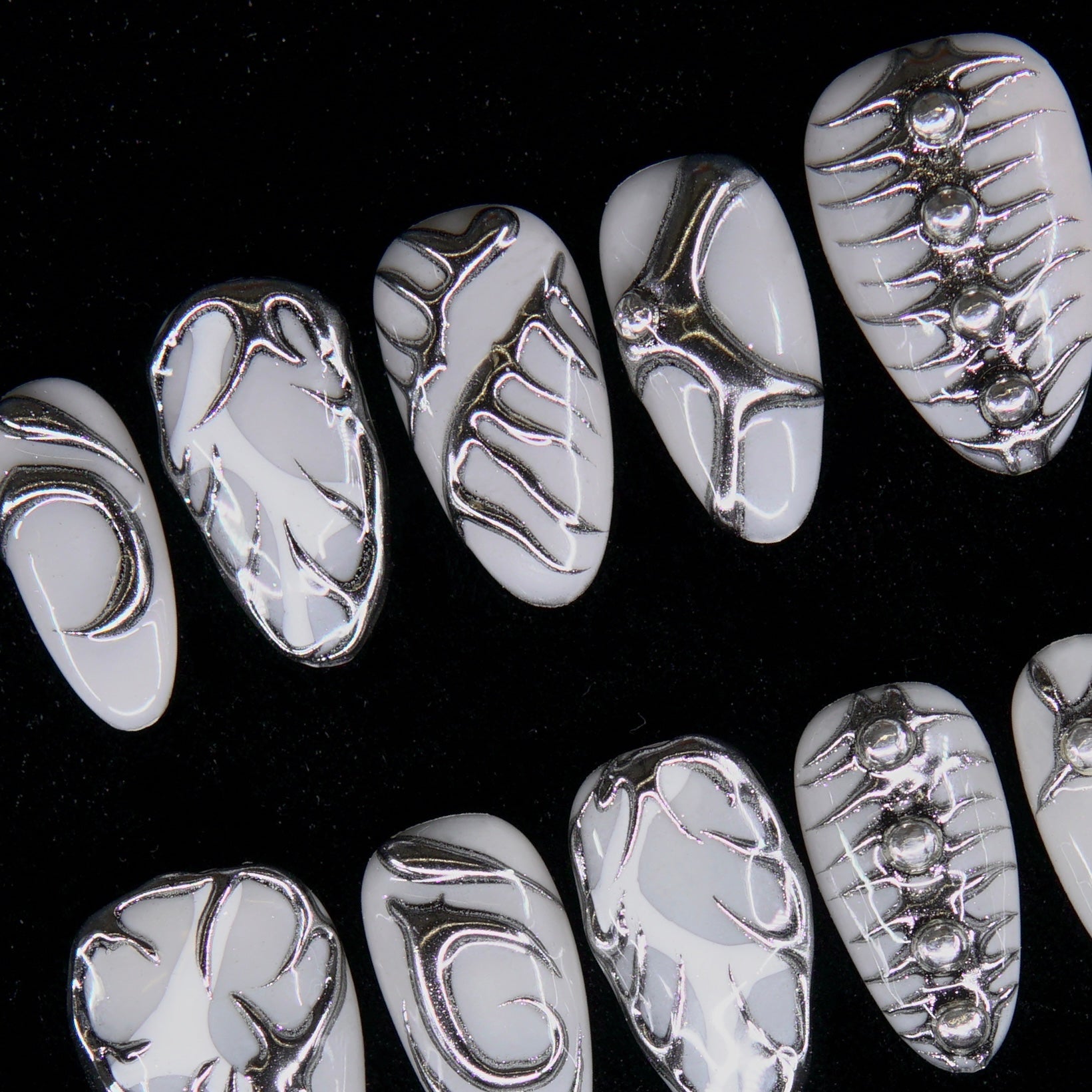 Macro of geometric chrome patterns with light contrast.