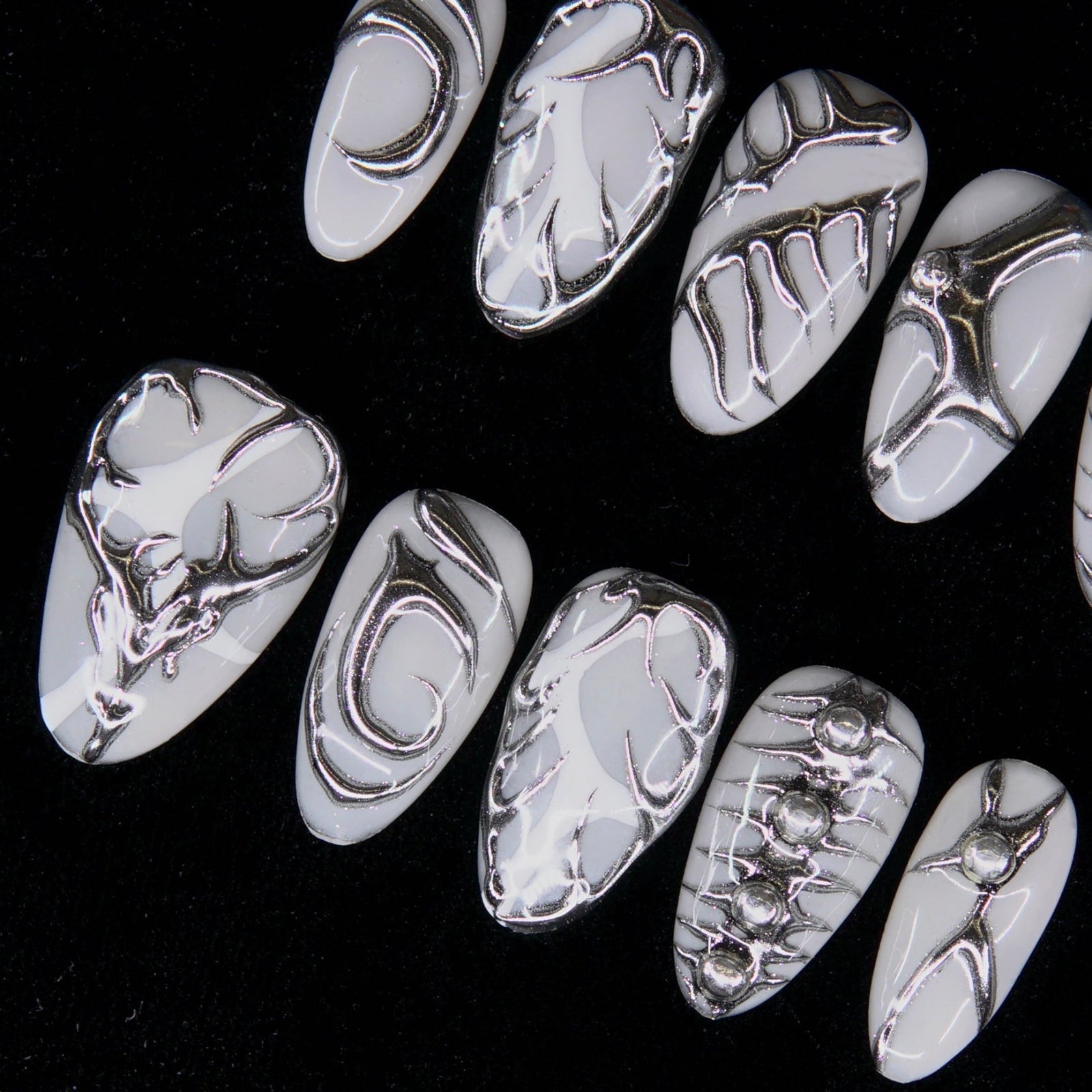 Macro of geometric chrome patterns with light contrast.