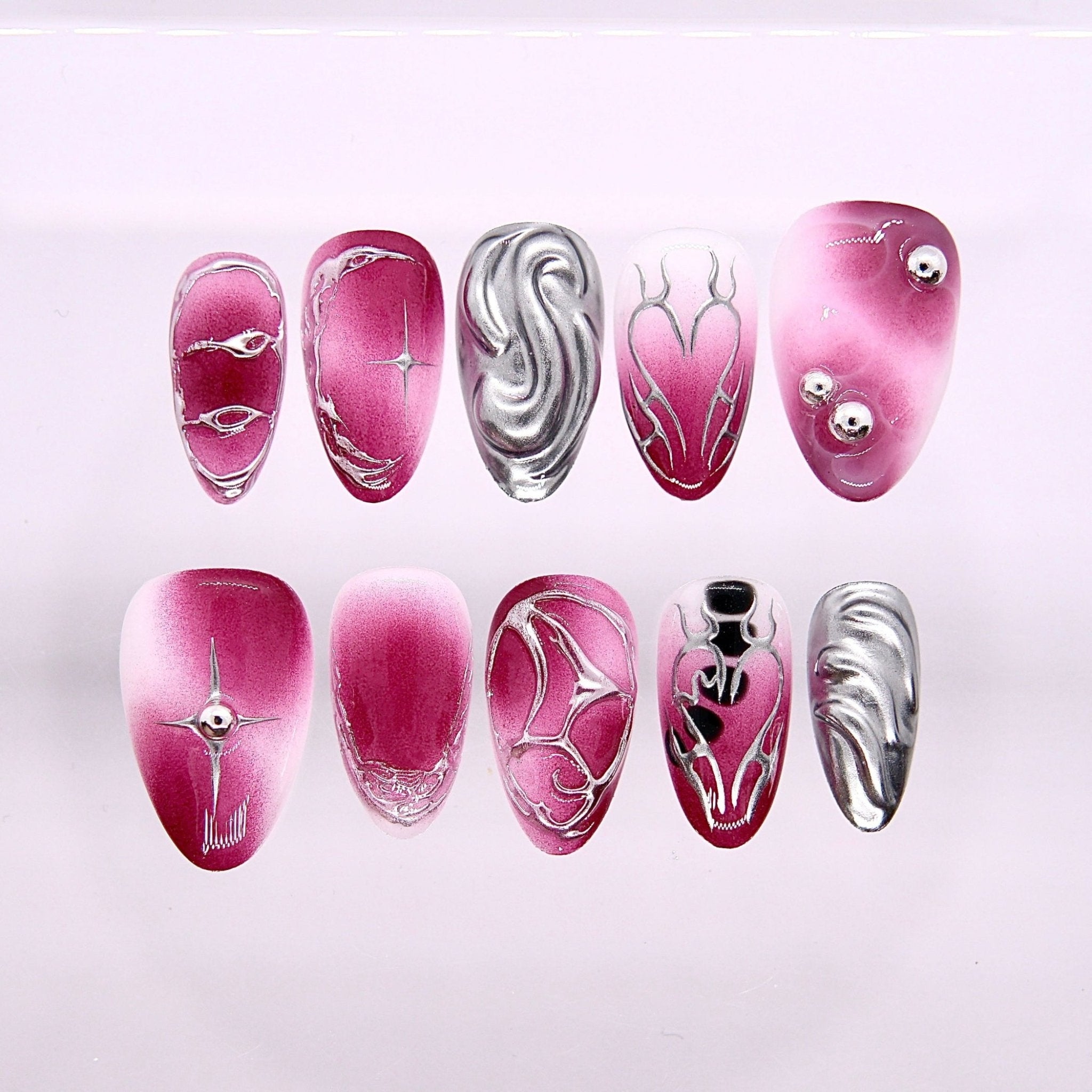 Begin as Yourself press-on nails set featuring expressive pink tones with sculptural silver metallic accents