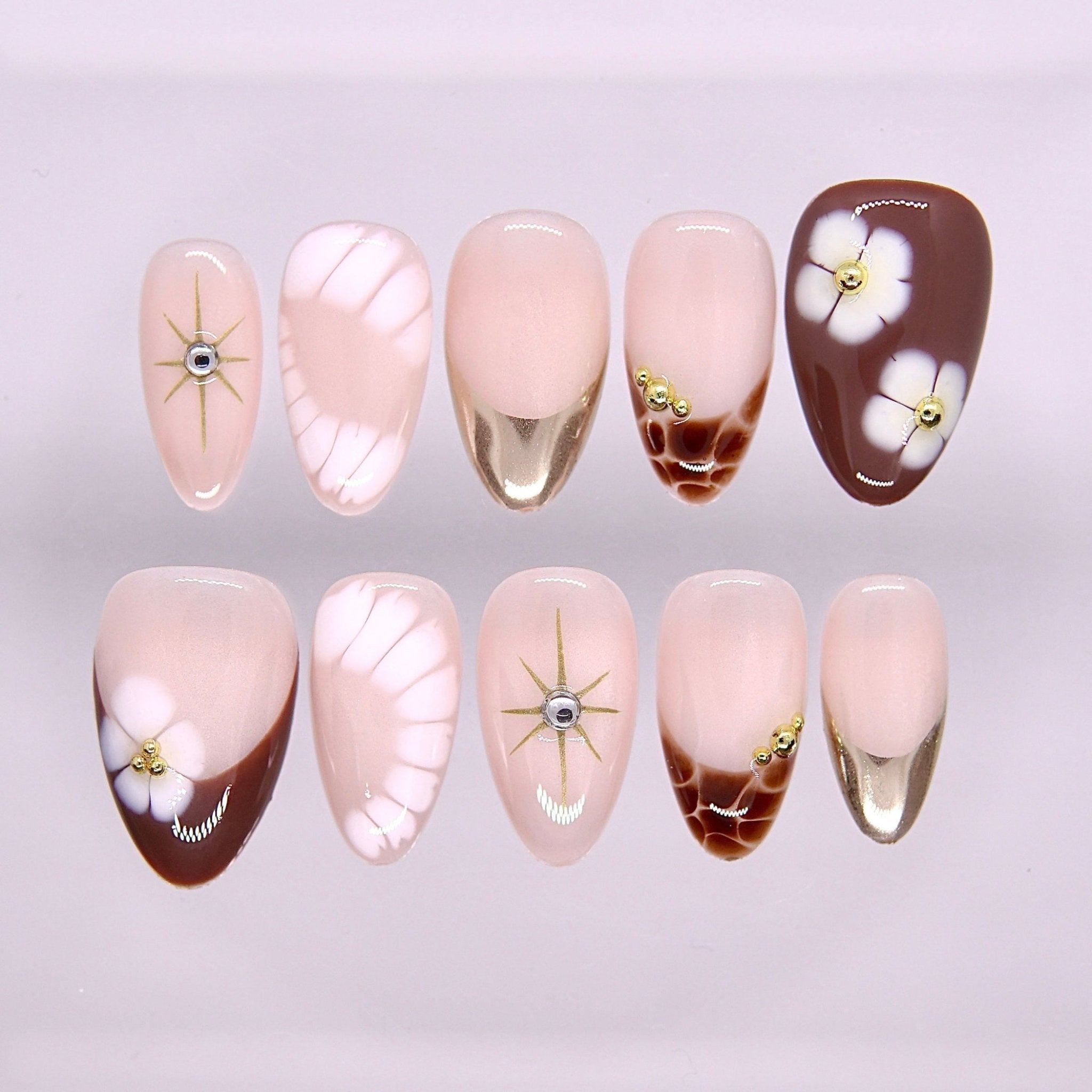 Begin at Heart press-on nails set featuring blush pink and warm brown tones with floral details and subtle gold accents