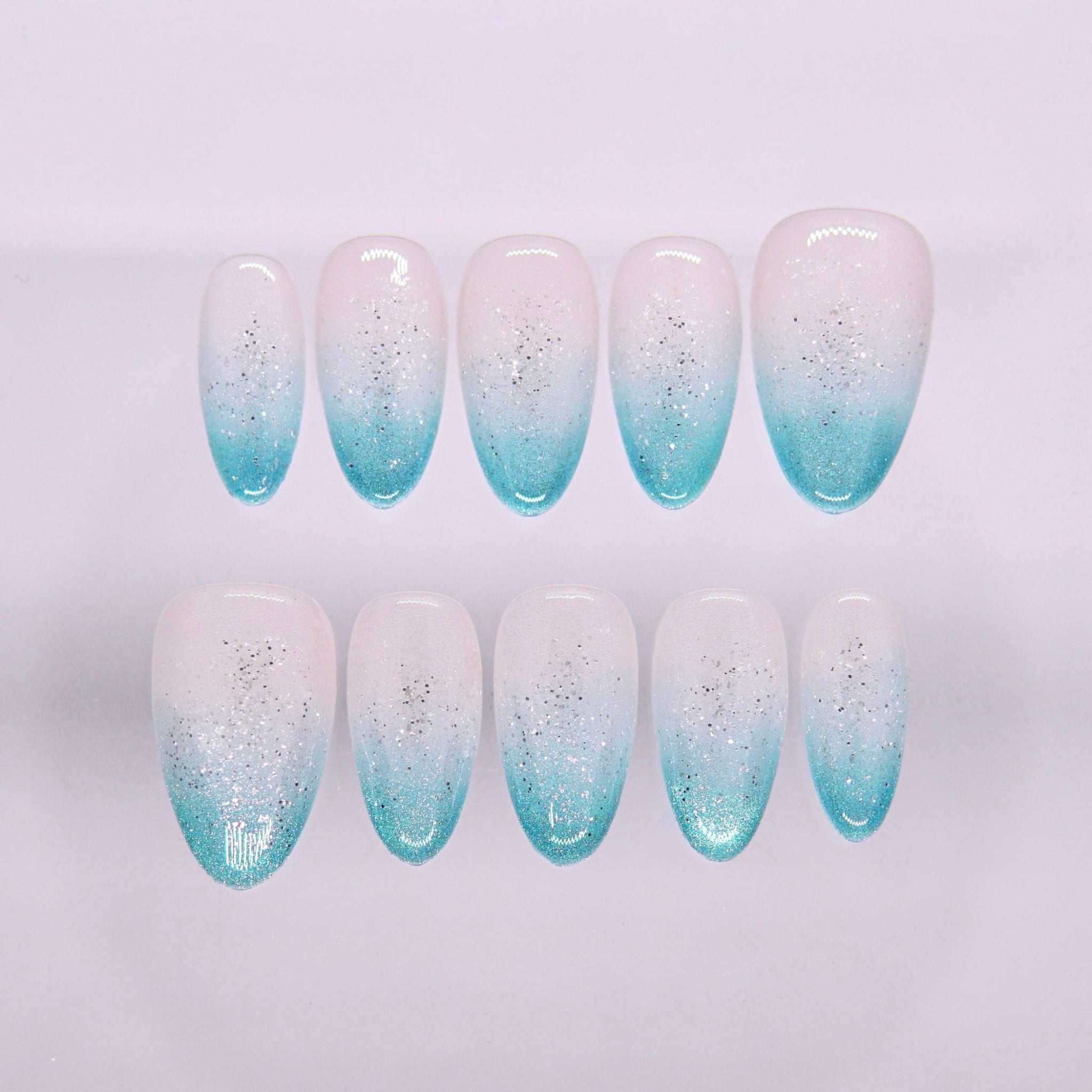 Begin with Clarity press-on nails set featuring white to aqua blue ombré with subtle shimmer finish
