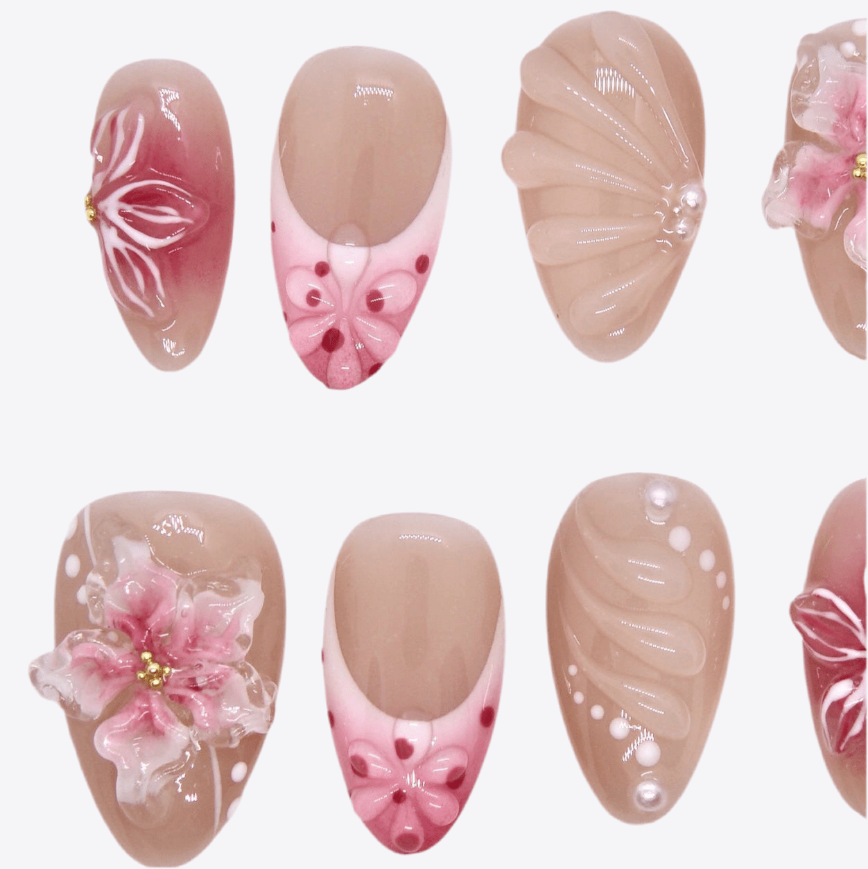 Detailed view of pearl accents and soft pink ombré base on handcrafted press-on nails.