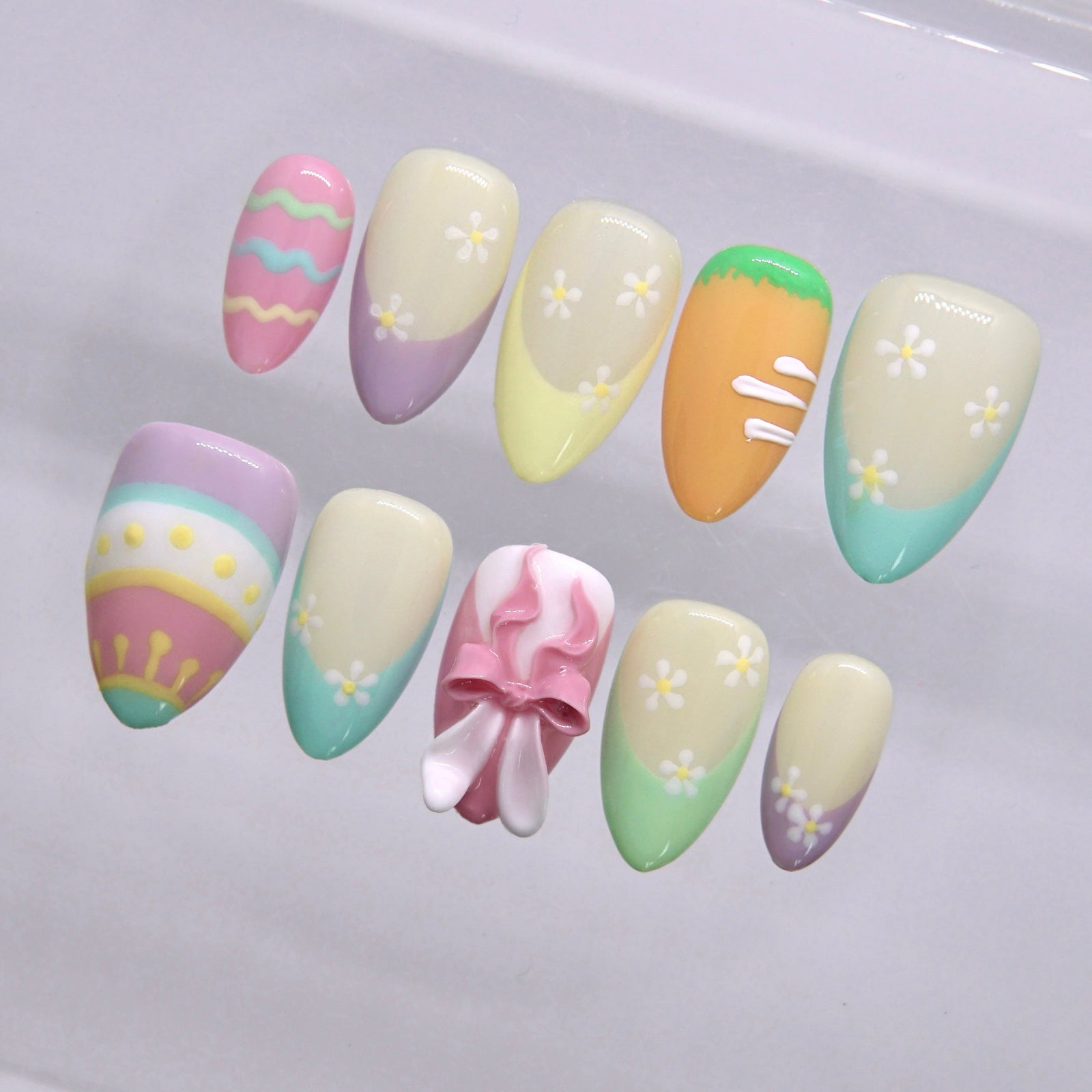 Colorful pastel nail art with Easter egg pattern and daisy details
