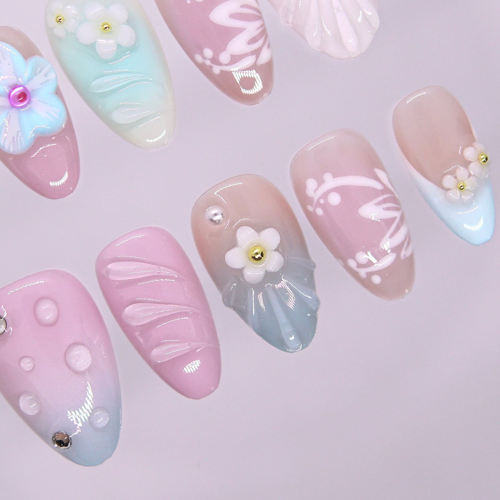 Soft mint, blush, and baby blue gradient press-on nails with candy-like pastel tones.