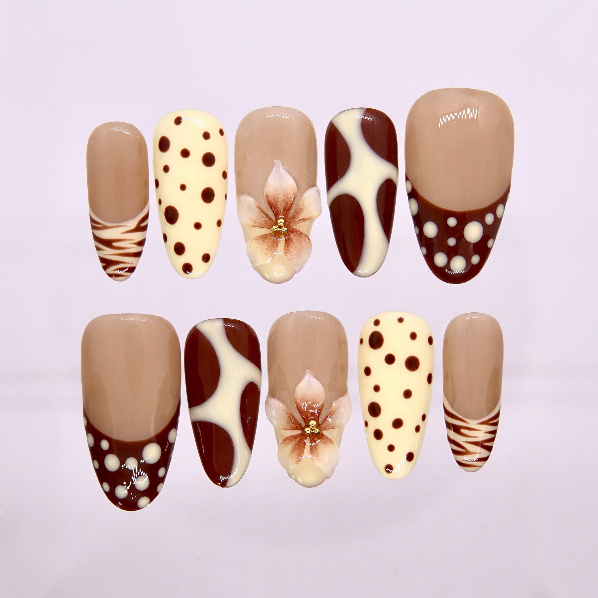 Caramel Bloom press-on nails with latte brown, cream dots, and 3D flower centerpiece.