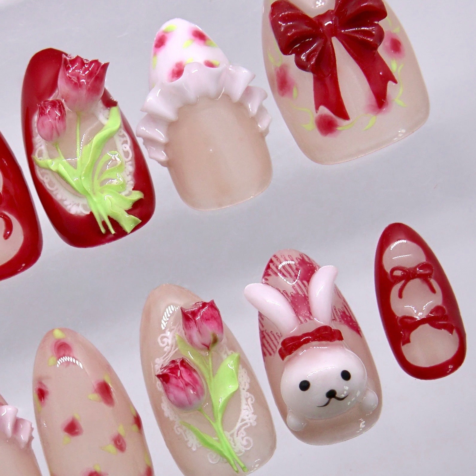 Cute bunny nail art with soft pink base and sculpted details

