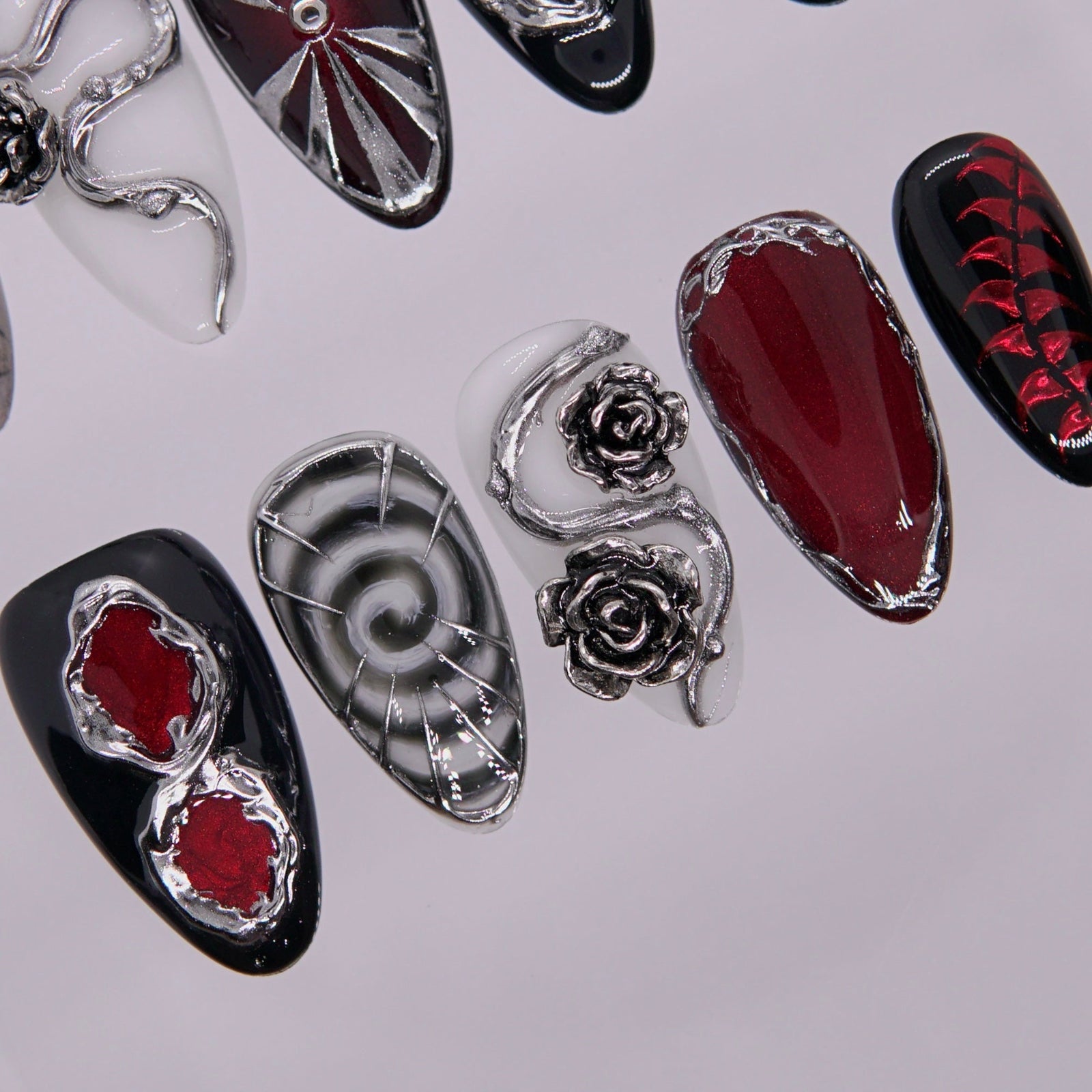 Black-red gradient nail with alchemical pattern.