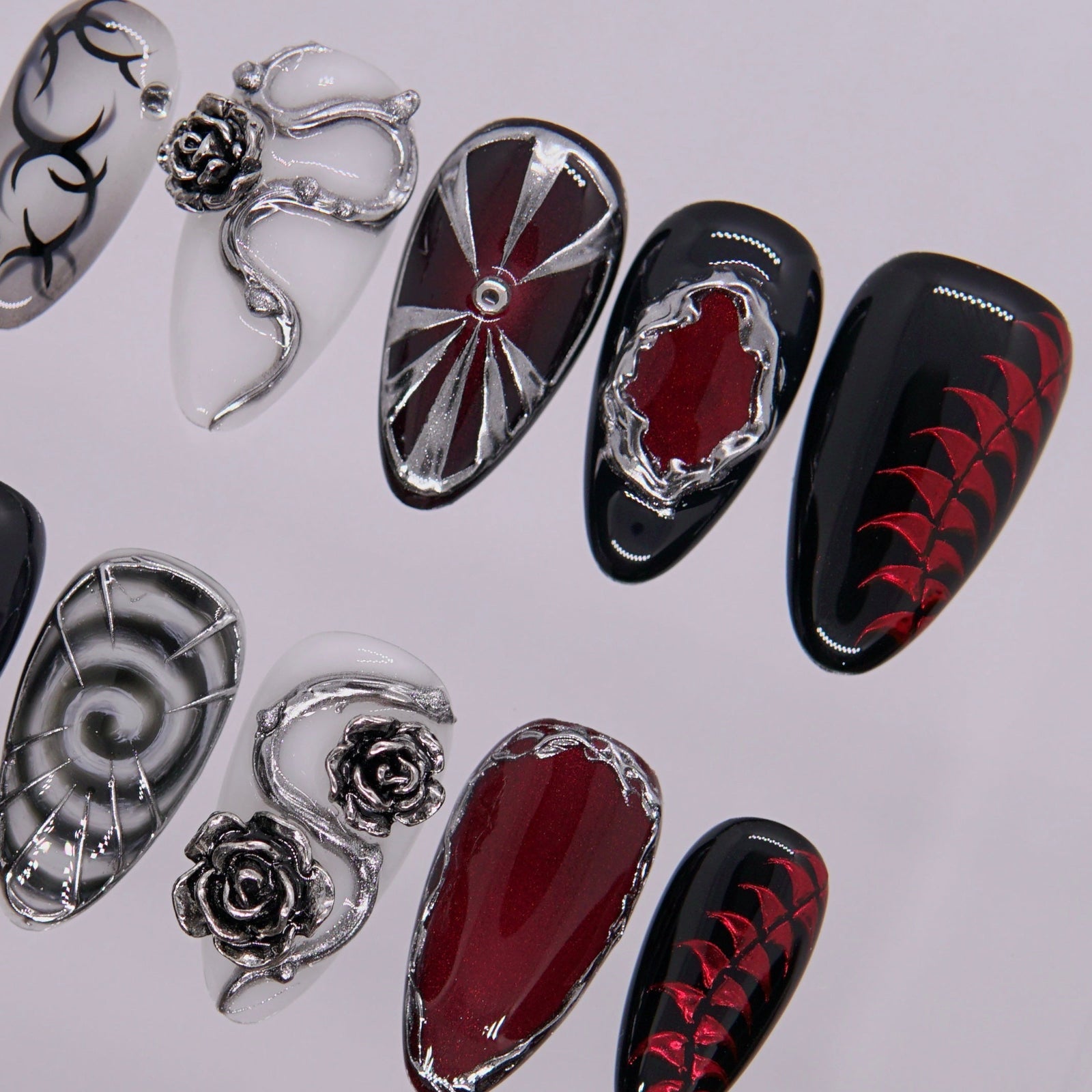 Black-red gradient nail with alchemical pattern.