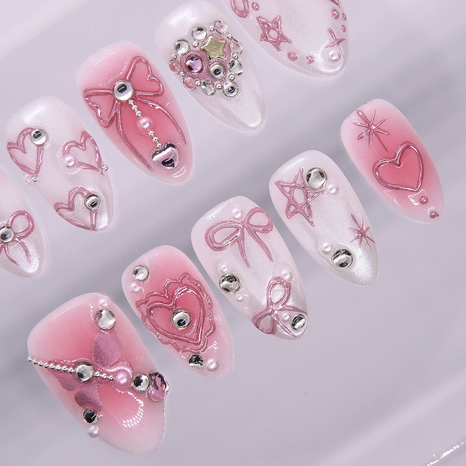 White chrome base with 3D star and ribbon carvings and soft pink gradient.