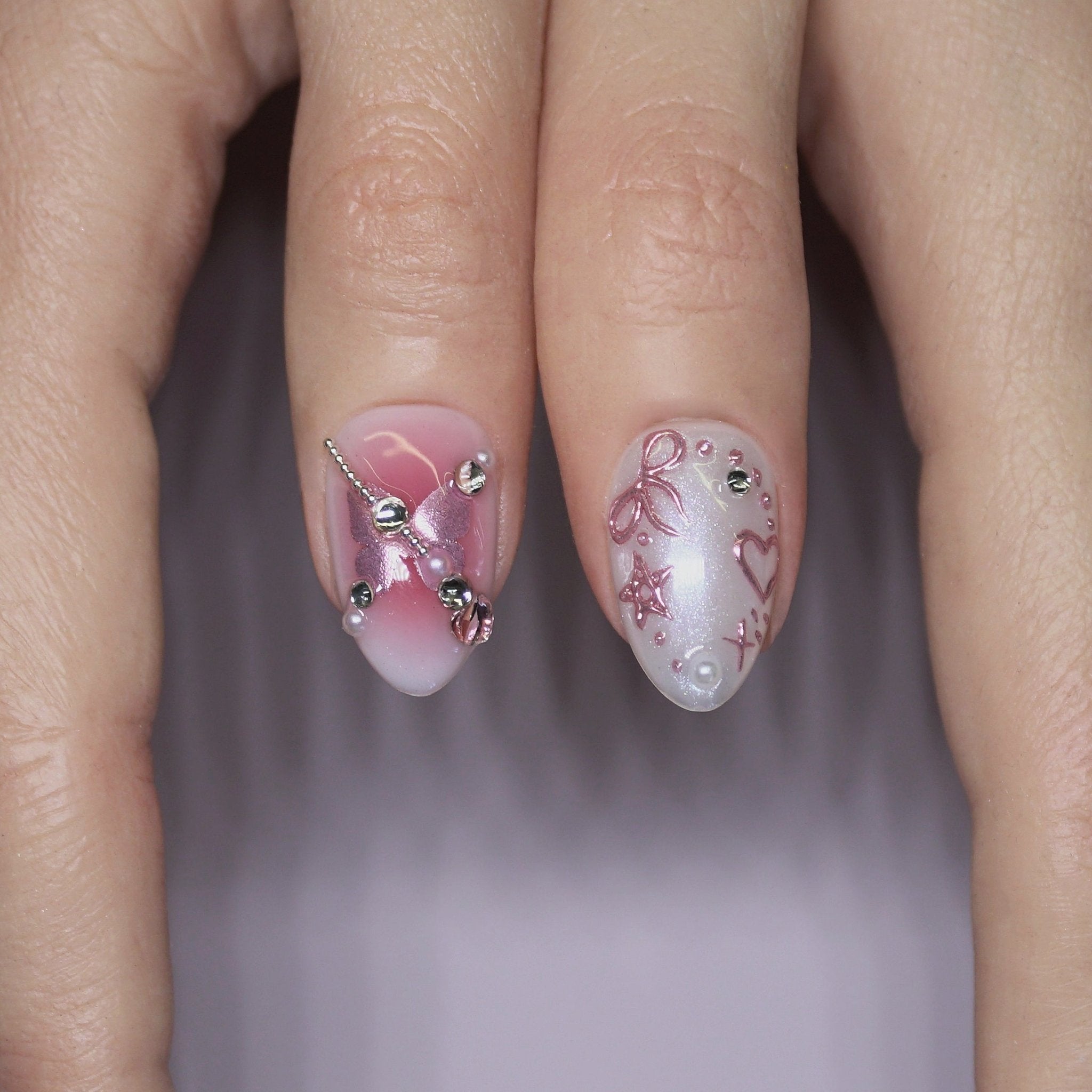 Model wearing Cosmic Crush nails while journaling or holding a plushie, with soft pastel lighting and cozy dreamy setup.