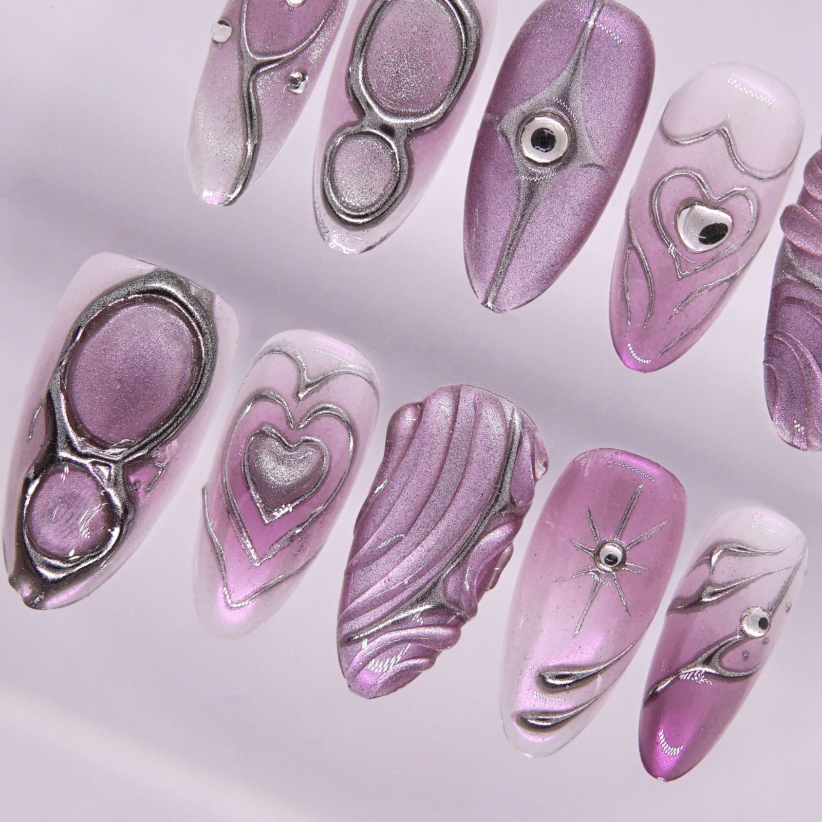 Lilac gradient nail with rhinestone shimmer.