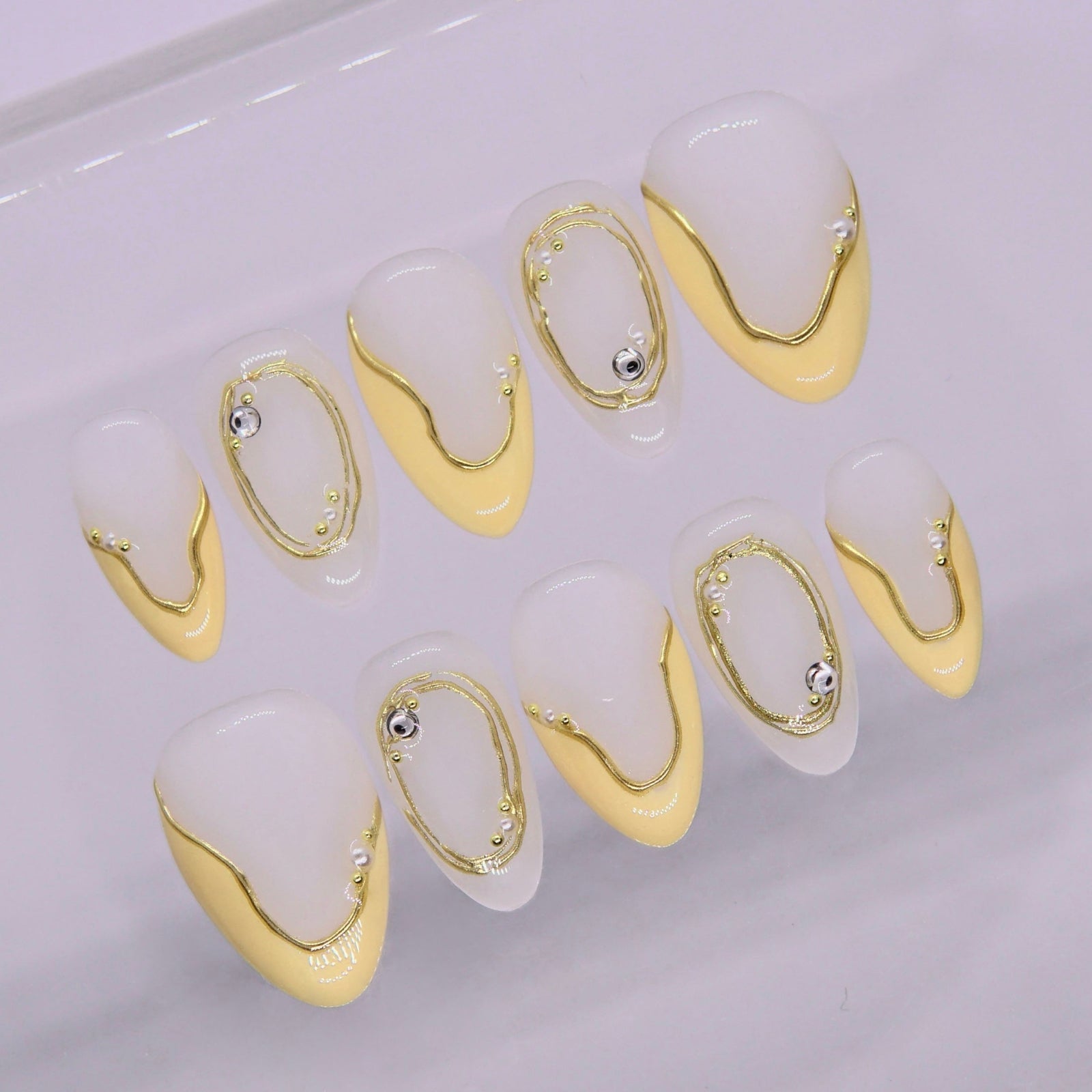 Close-up of yellow nails with smooth dripping effect and glossy finish